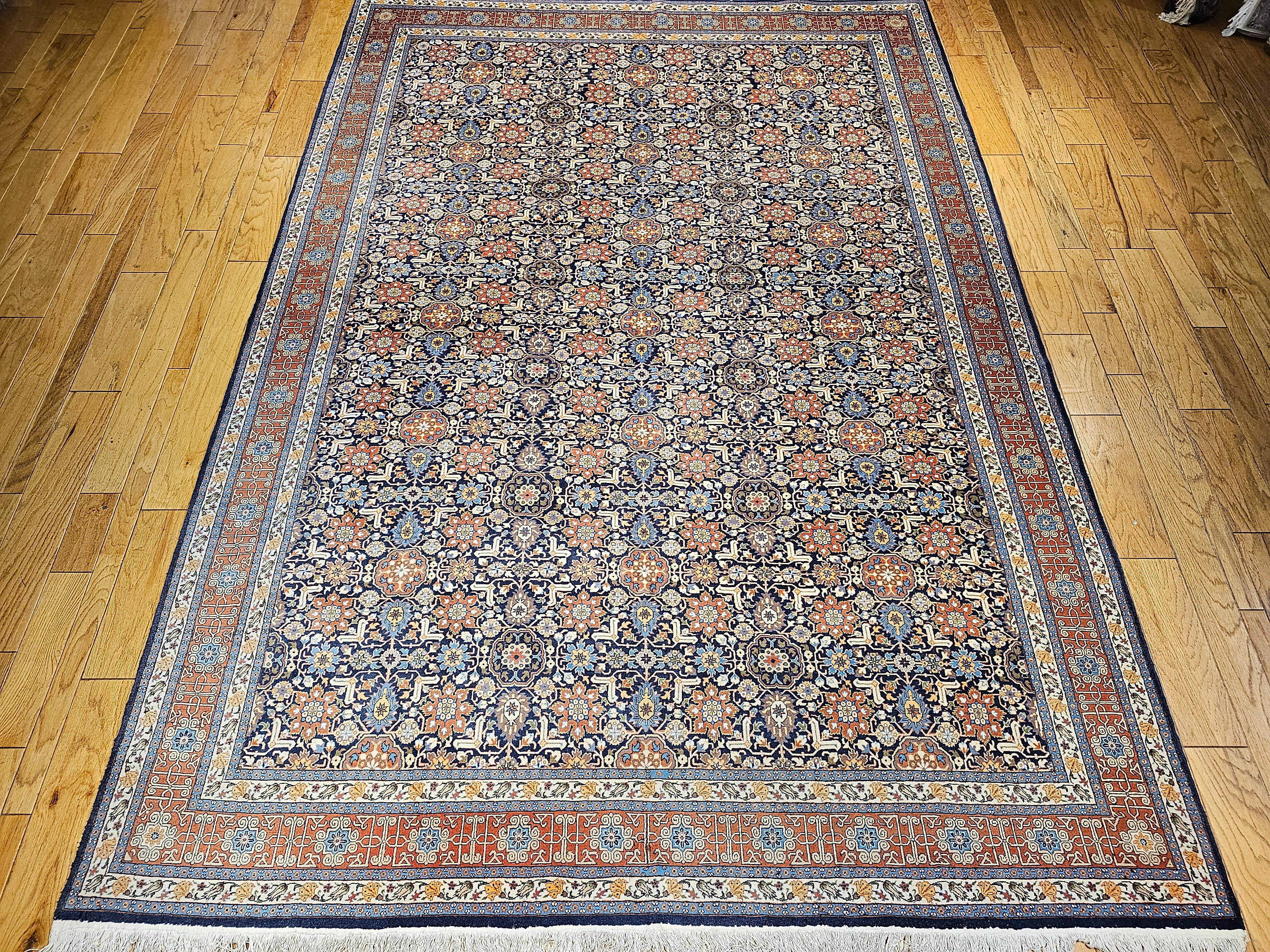 A vintage room size Persian Tabriz in a rare “Afshan” allover pattern set in a navy blue field with a red border circa the 2nd quarter of the 1900s.  The design of this Tabriz rug is following the design of the Caucasian Kuba and Shirvan rugs from