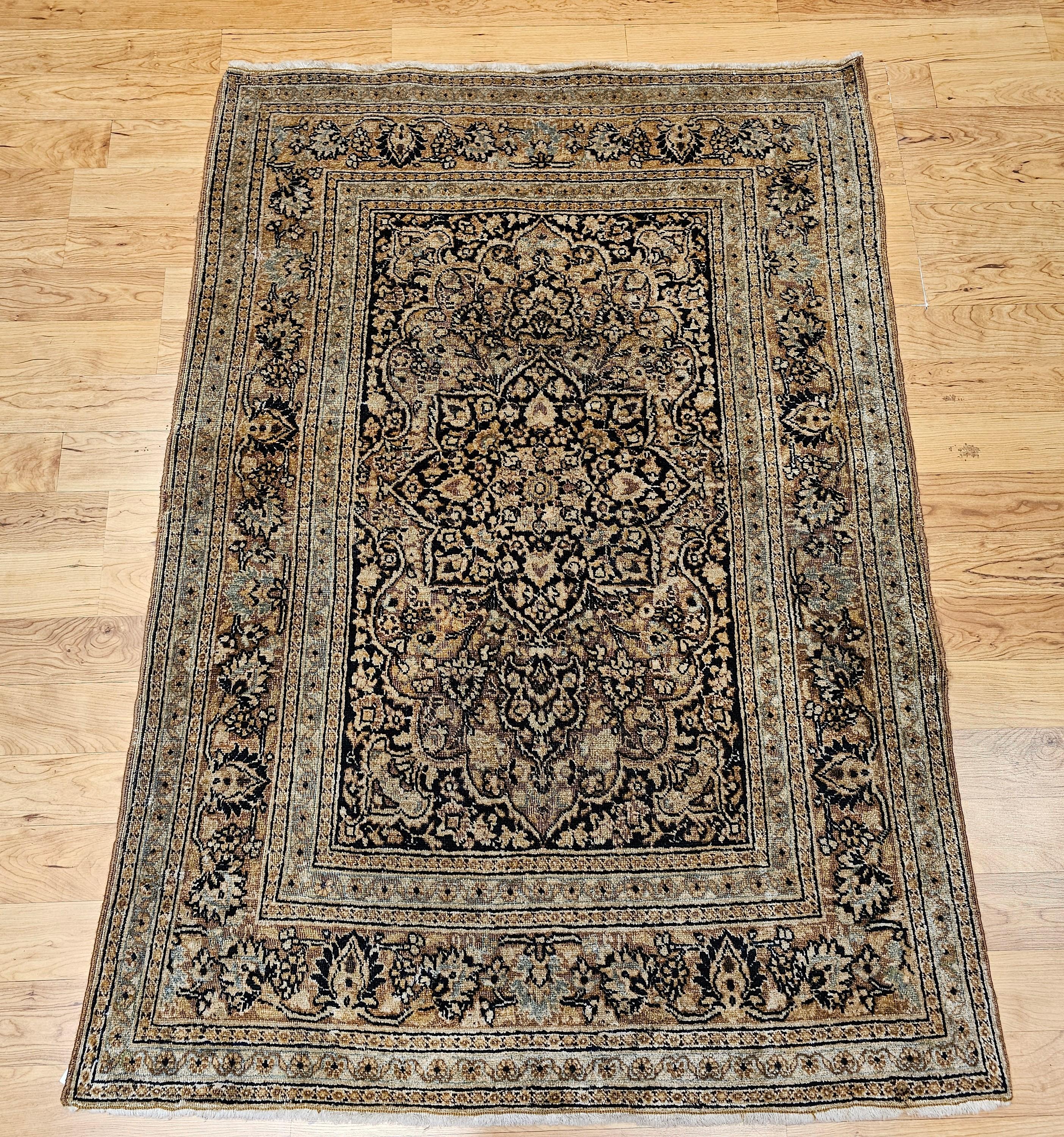 Wonderfully graceful and understatedly beauty is clearly visible in this fine weave vintage Persian Tabriz area rug in a medallion floral pattern from the early 1900s.  The Tabriz rug has a dark midnight blue/black background color with floral