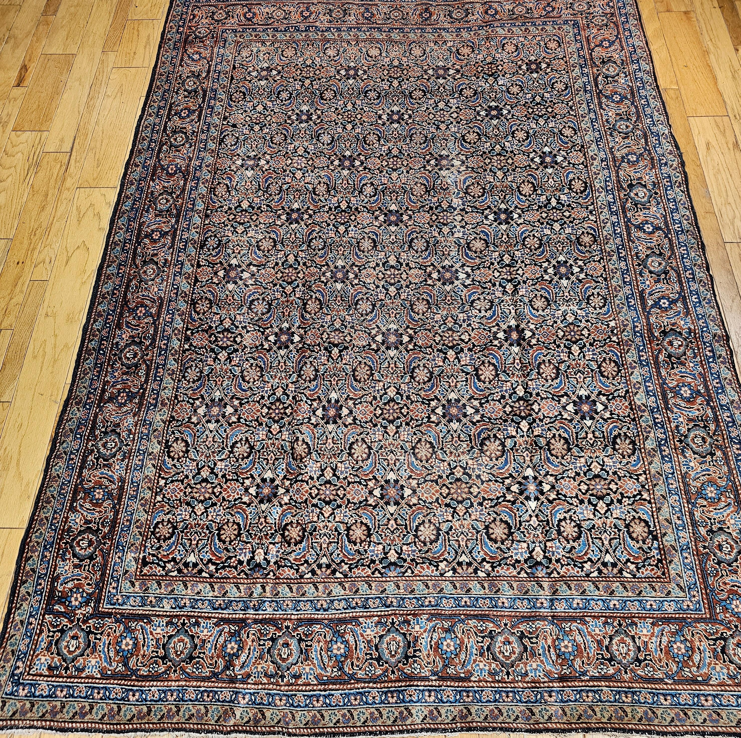 Beautiful room size Persian Tabriz in an all-over Herati  pattern from the first quarter of the 20th century.  The Tabriz rug has a Herati all-over pattern set in a navy color background with a navy blue border.  The other colors in the field and