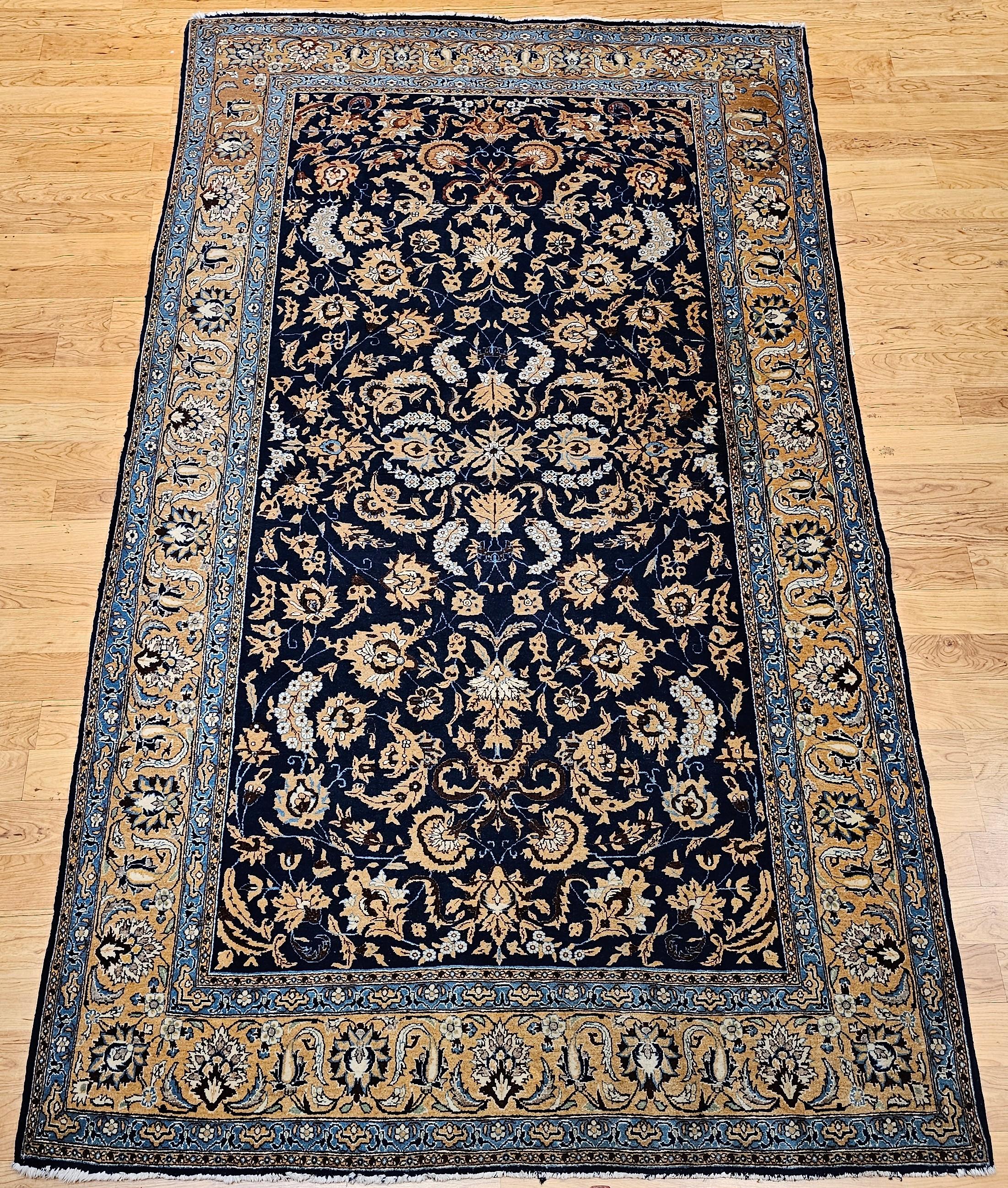 Beautiful room-size Tabriz rug from the early 1900s in an allover pattern similar to Safavid dynasty era “Sickle and Leaf” pattern with a navy blue background color.  The branches and leaves are in caramel, chocolate, rust, and pale blue colors.  It