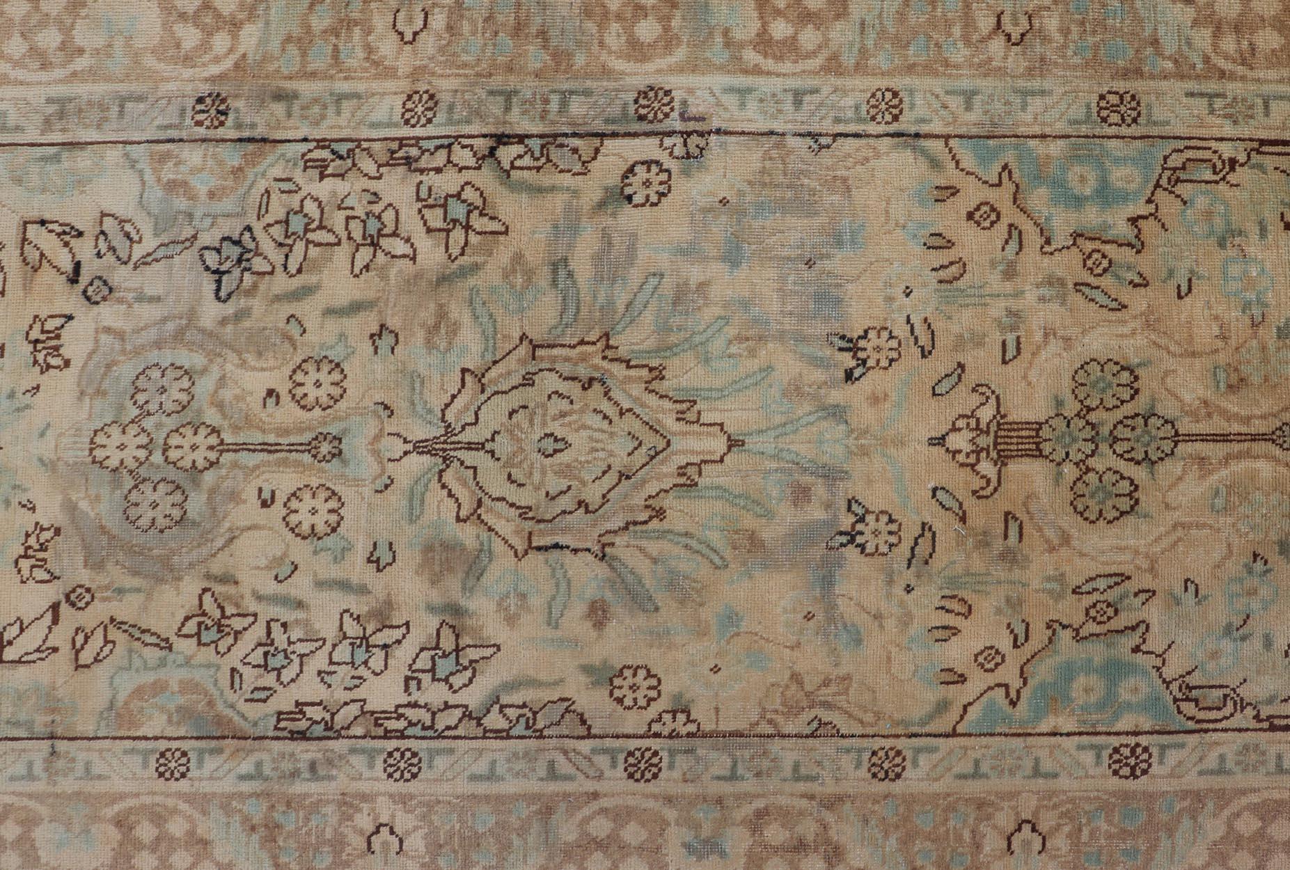 Floral design vintage Persian Tabriz long runner in neutral tones of taupe, tan, brown, taupe, gray, light blue and dark blue. Keivan Woven Arts / rug H-102-13, country of origin / type: Iran / Tabriz, circa 1950

This vintage Persian Tabriz