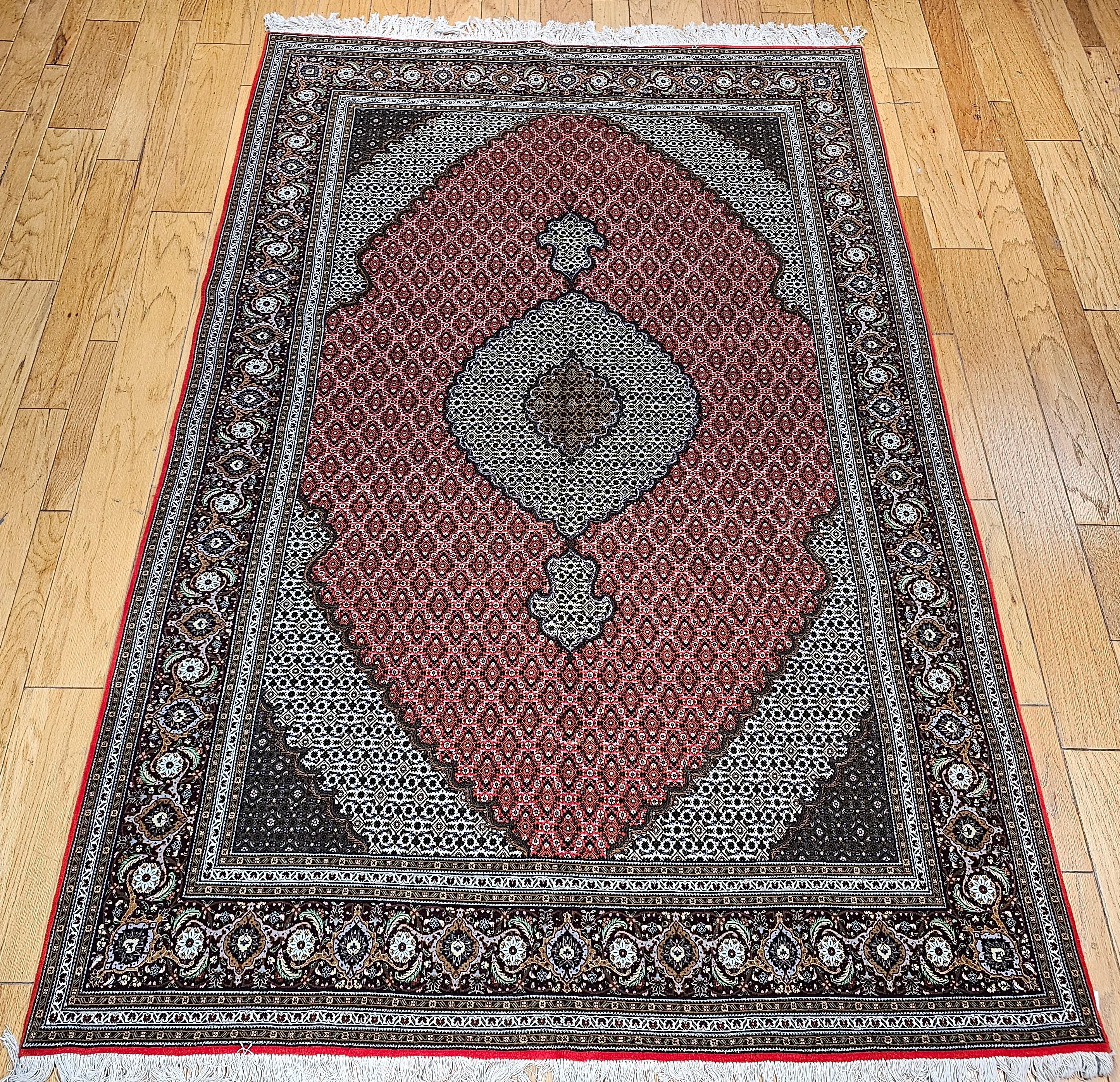 Vintage Persian Tabriz in Mahi (Fish) pattern with silk highlights from the 3rd quarter of the 1900s.  The classic geometric pattern is loved in Persia and is hand-knotted in several cities in the Azerbaijan Province of Persia.  The best of these