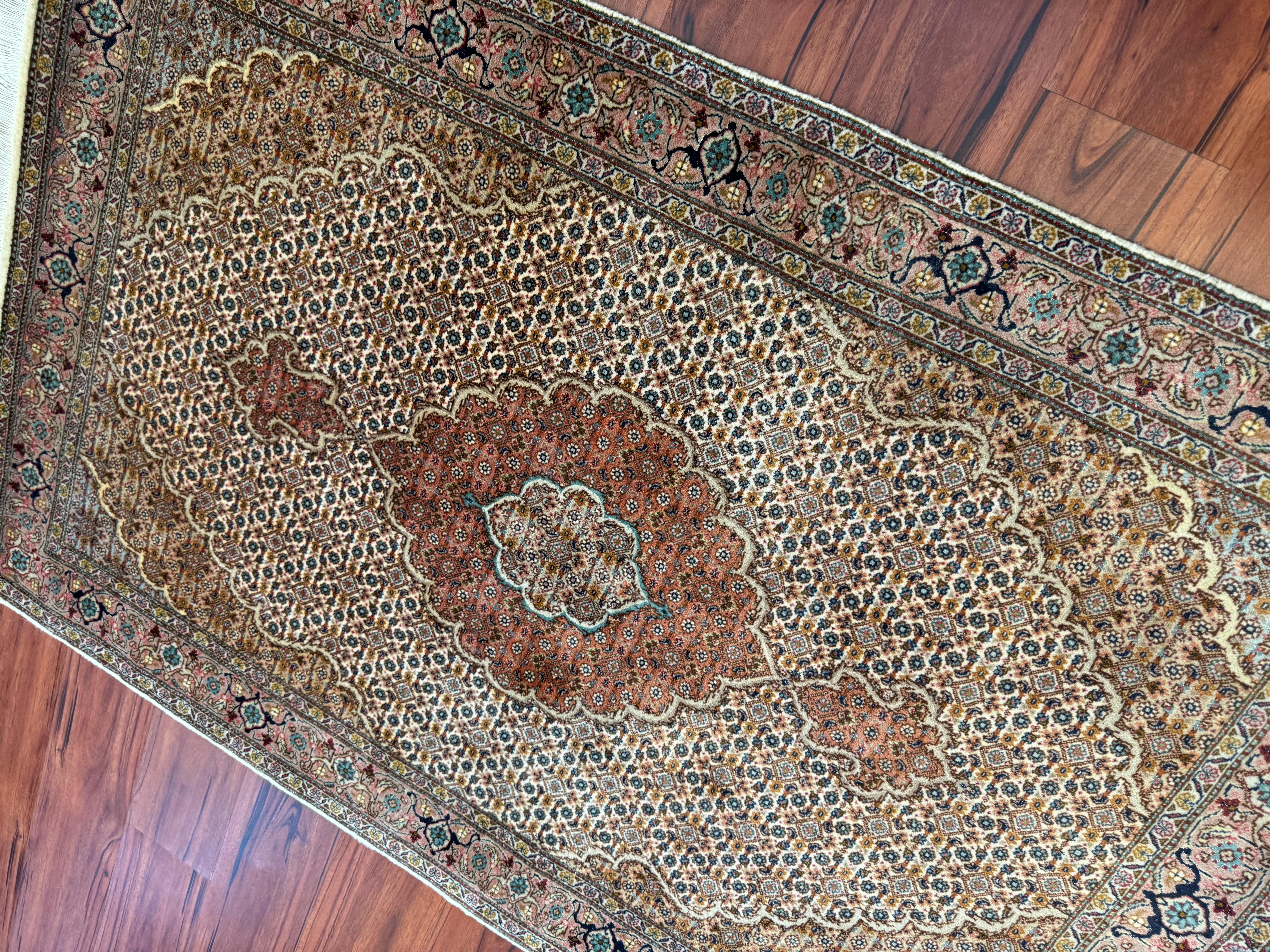 A stunning Vintage Persian Tabriz Mahi Rug that originates from Iran in the mid-20th century. This rug is in excellent condition considering its rich history and is made from a combination of wool, silk, and cotton. A truly gorgeous rug with its