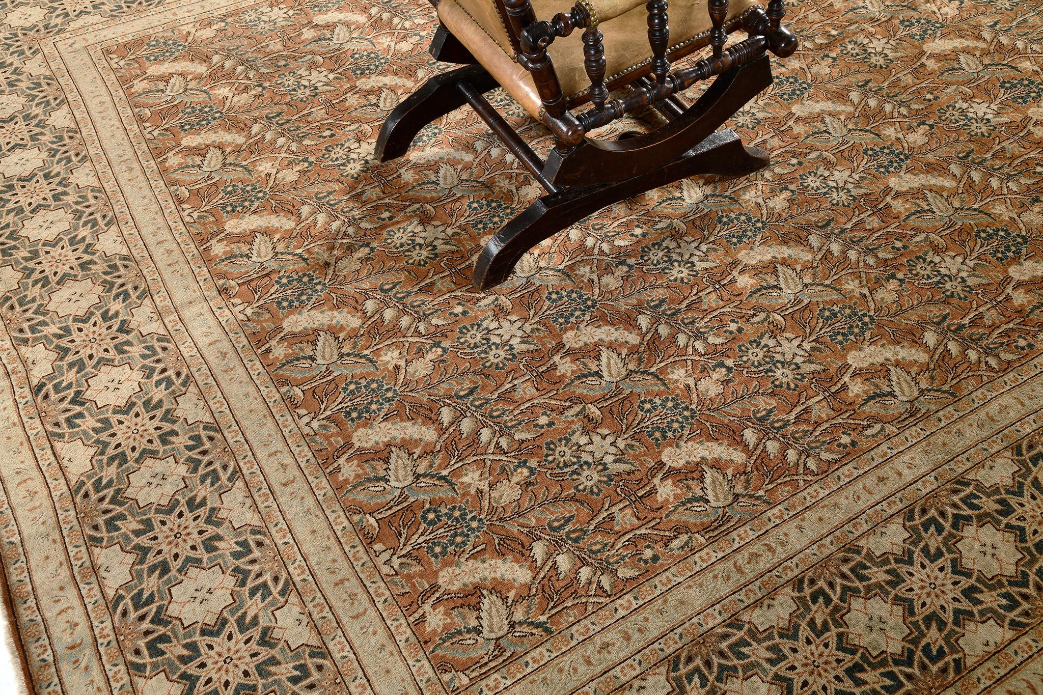 This hand spun wool classic Tabriz rug from Persia, has never failed to mesmerize because of its stunning details. It has a perfect alignment of geometric patterns and the symmetric blooming wheat field incorporated with the touch of ash gray