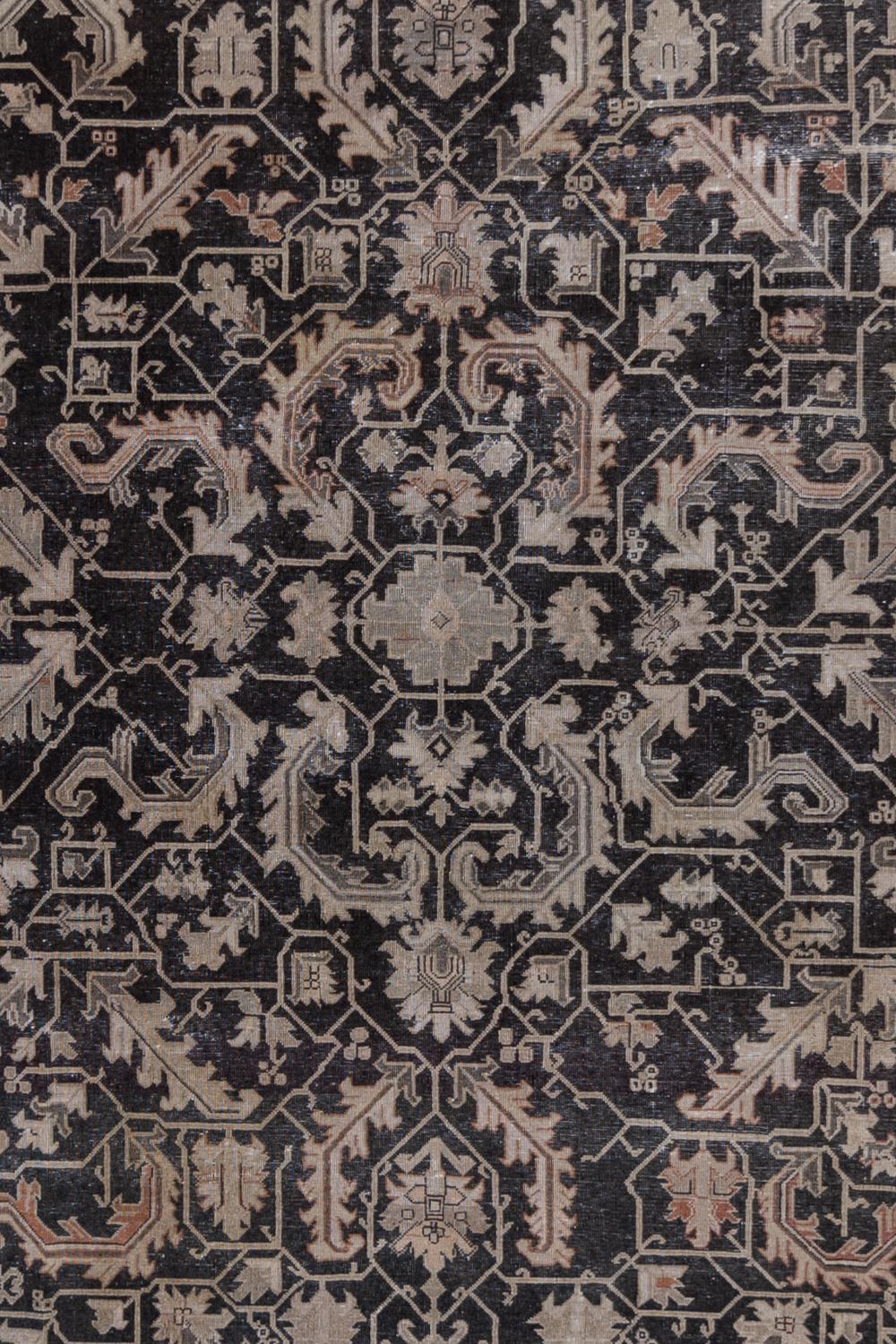 Age: Circa 1940

Colors: dark blue-black (faded black), taupe, salmon accents, mushroom

Pile: low

Wear Notes: 2

Material: wool on cotton

Vintage Persian Tabriz with a dark field and geometric leaves in various shades of light gray