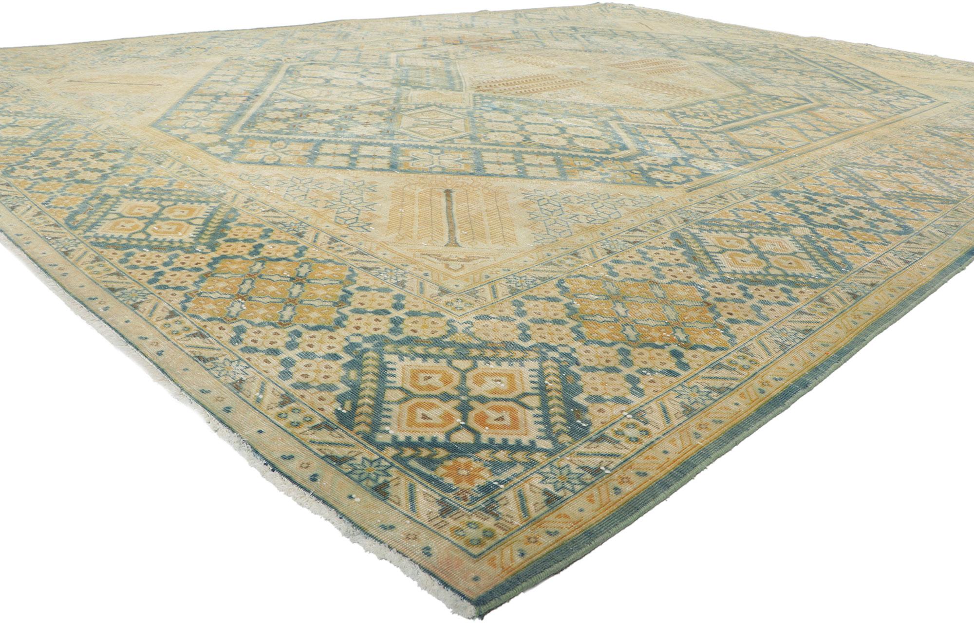 60997 Vintage Persian Tabriz rug, 10.04 x 14.03.
Showcasing timeless style with incredible detail and texture, this hand knotted wool vintage Persian Tabriz rug is a captivating vision of woven beauty. The geometric design and soft colorway woven