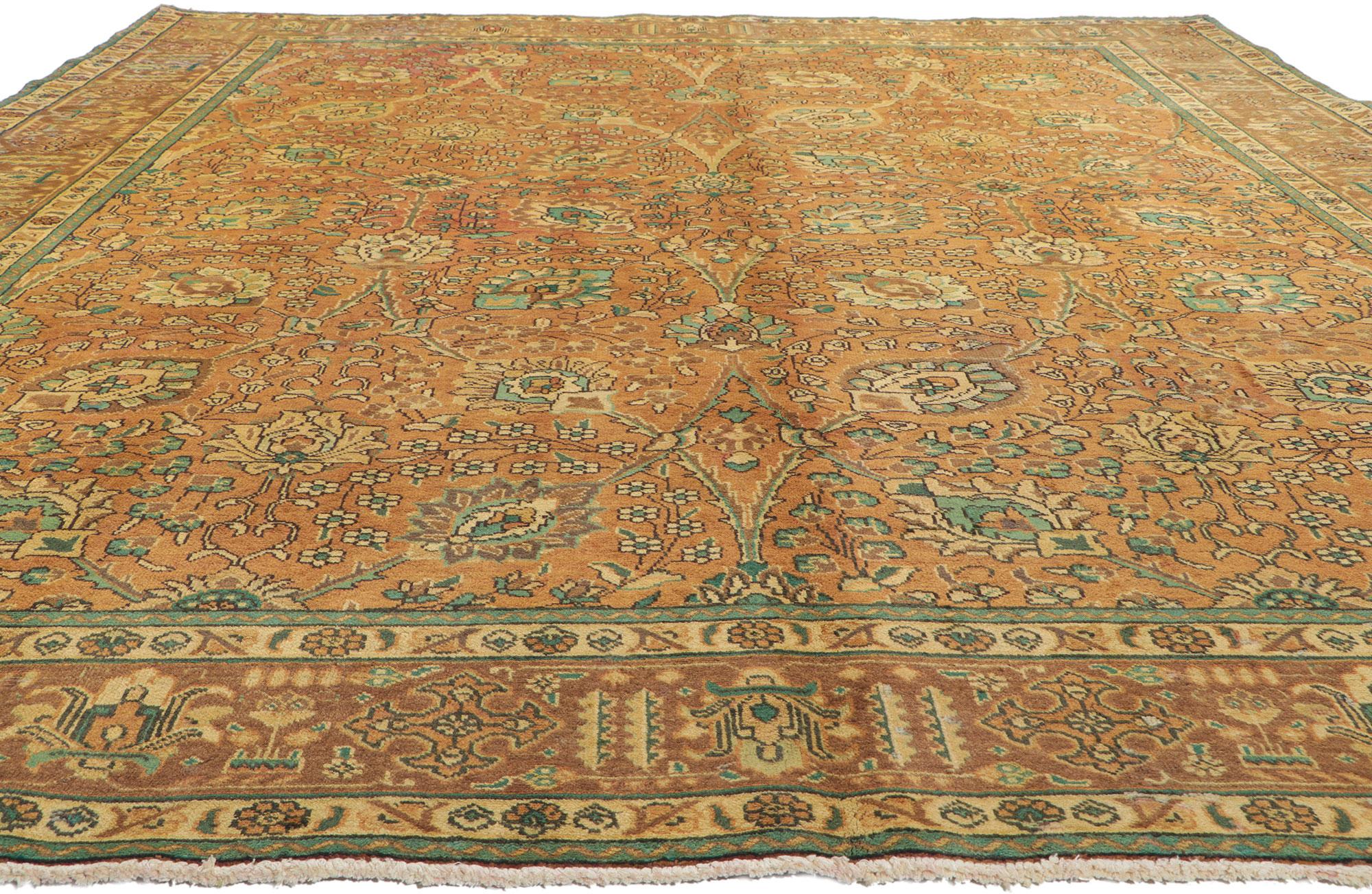 76312 Vintage Persian Tabriz rug, 09'09 x 12'04. Emanating timeless style with incredible detail and texture, this hand knotted wool vintage Persian Tabriz rug is a captivating vision of woven beauty. The traditional design and earthy colorway woven