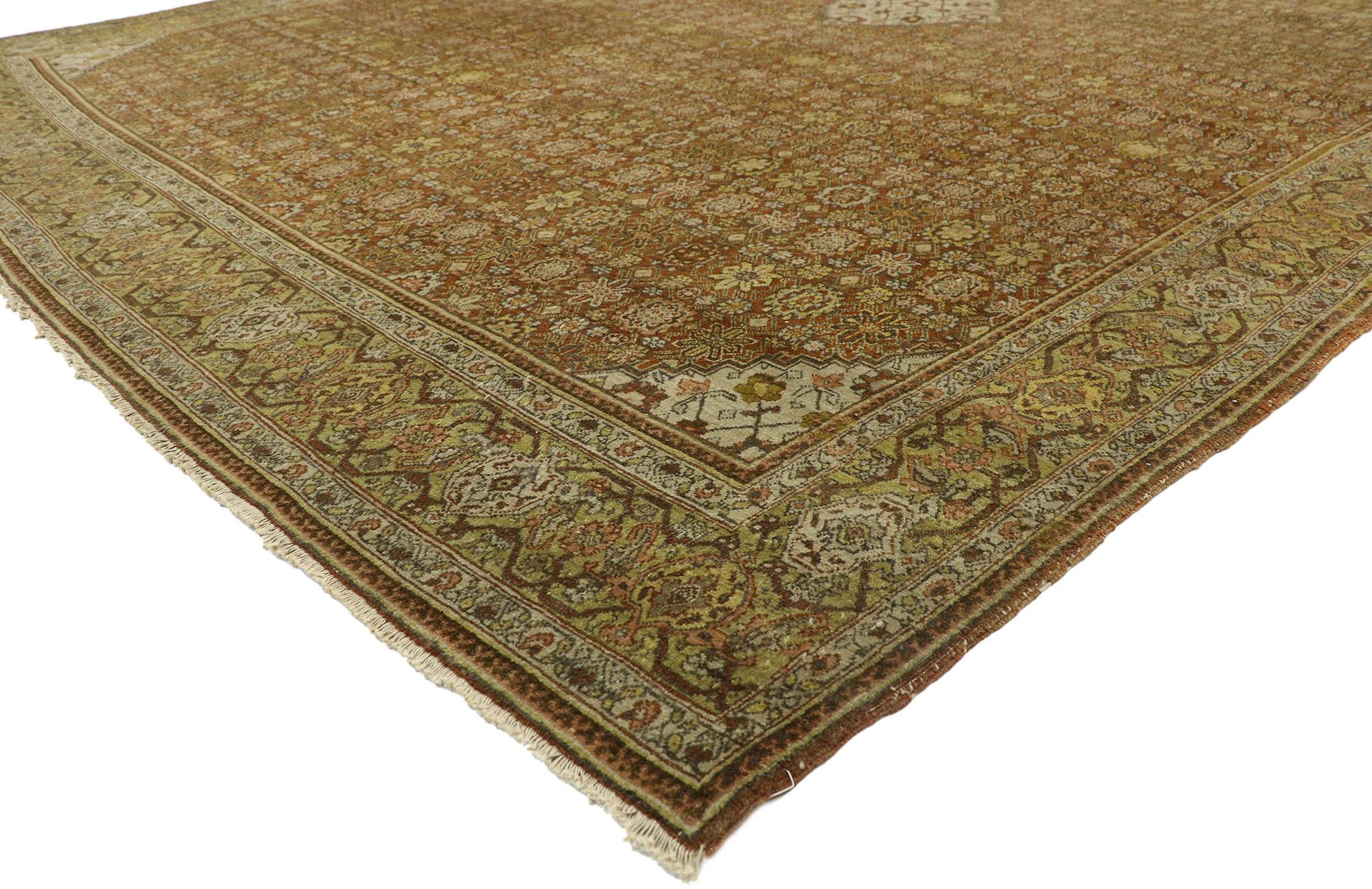 77394, antique Persian Tabriz rug with Arts & Crafts style. With its warm earth-tone colors and symmetrical composition, this hand knotted wool vintage Persian Tabriz rug astounds with its beauty. It features a stepped lozenge central medallion