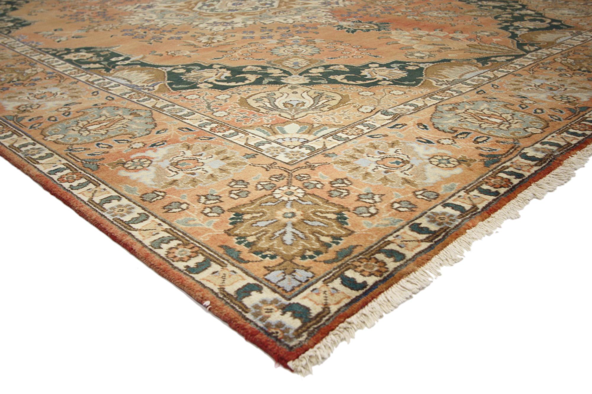 75586 Vintage Persian Tabriz Rug, 09'09 x 12'05. Balancing a timeless design with a romantic rustic sensibility, this hand knotted wool distressed vintage Persian Tabriz rug beautifully embodies English Chintz Rustic style. A cartouche medallion