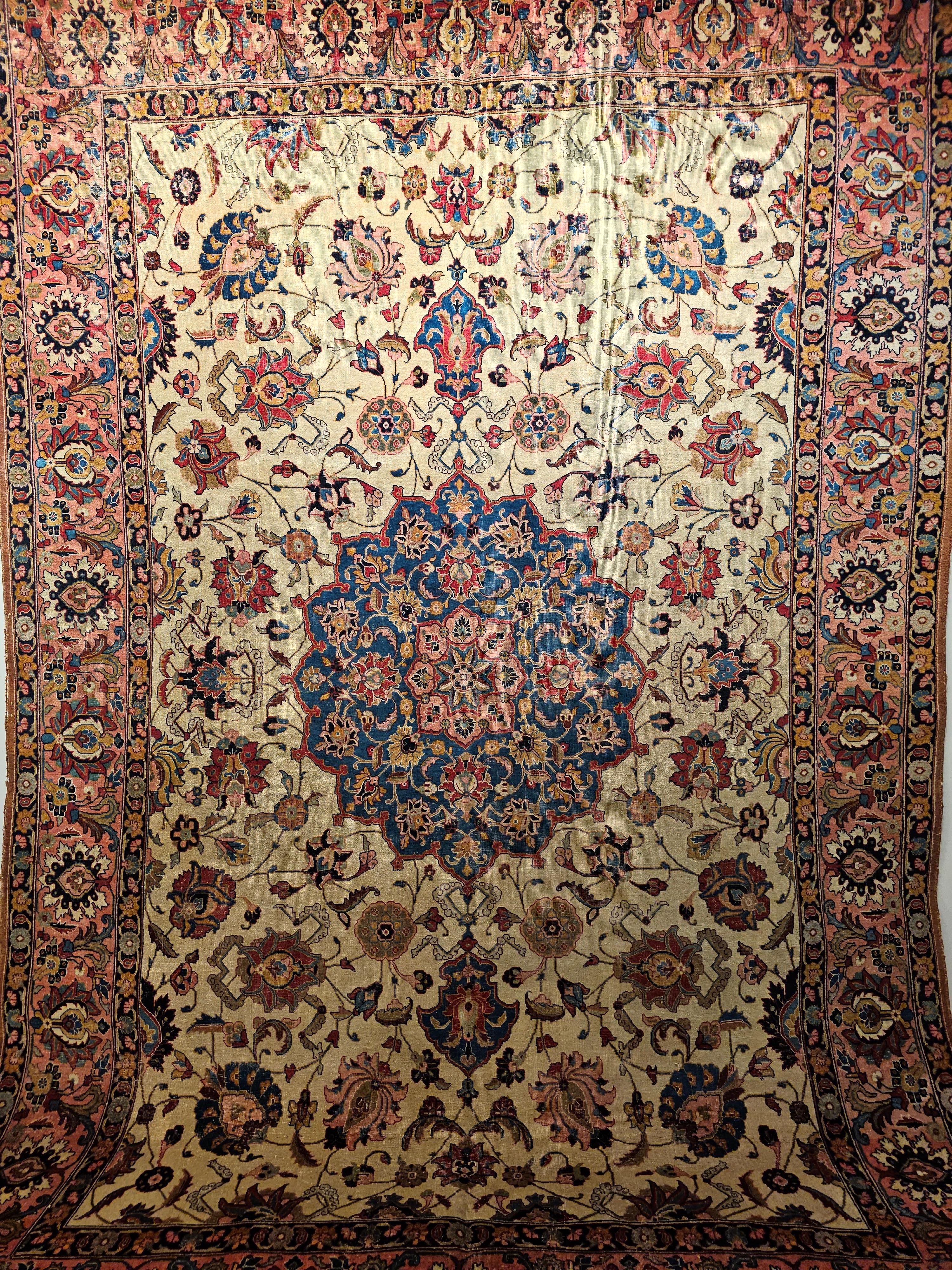 Vintage Persian Tabriz room size rug with large format floral pattern in French blue, ivory, and salmon colors. A beautiful Persian Tabriz room-size rug from the early 1900s. The rug has a wonderful design similar to the rugs woven during the 16th