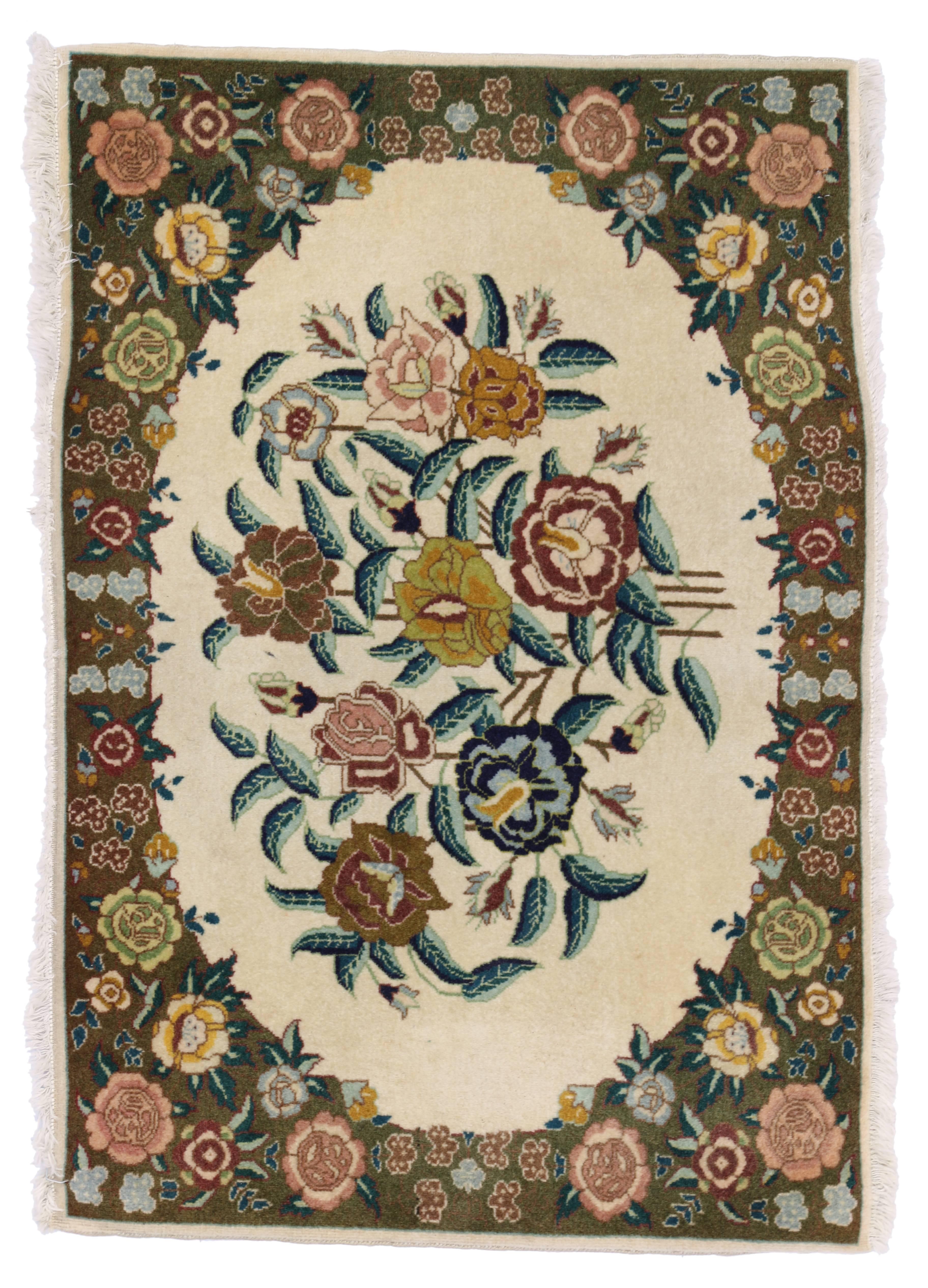75655 vintage Persian Tabriz rug with traditional style. This hand-knotted wool vintage Persian Tabriz rug features a floral bouquet in a creamy vanilla field surrounded by a complementary floral border creating a well-balanced and timeless design.