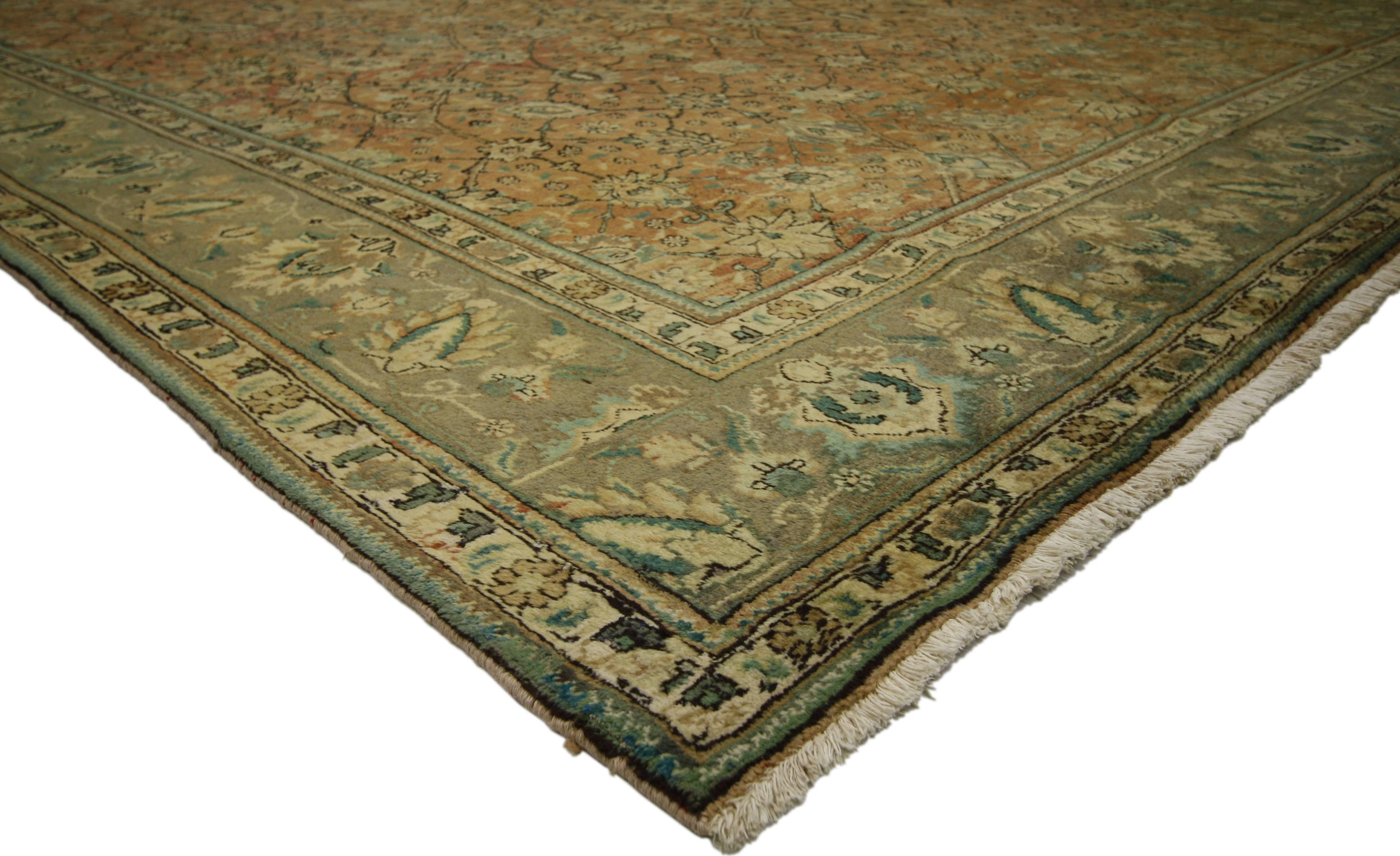 76329, vintage Persian Tabriz rug with traditional style. This hand-knotted wool vintage Persian Tabriz rug features an allover pattern surrounded by a classic border creating a well-balanced and timeless design. This vintage Persian Tabriz rug
