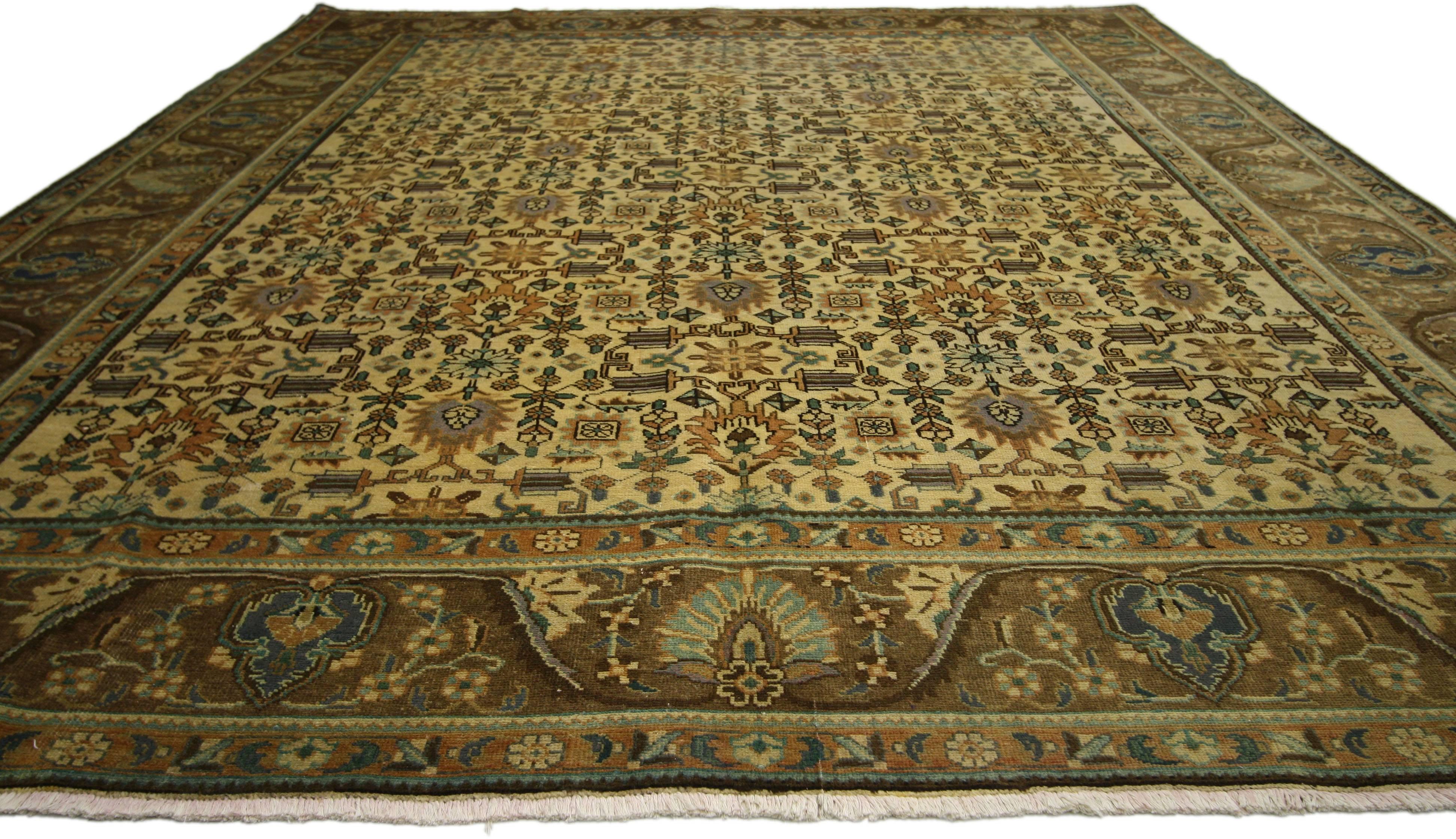 76360, vintage Persian Tabriz rug 09'08 x 12'07. This hand-knotted wool vintage Persian Tabriz rug features an all-over pattern surrounded by a classic border creating a well-balanced and timeless design. This vintage Persian Tabriz rug brings a