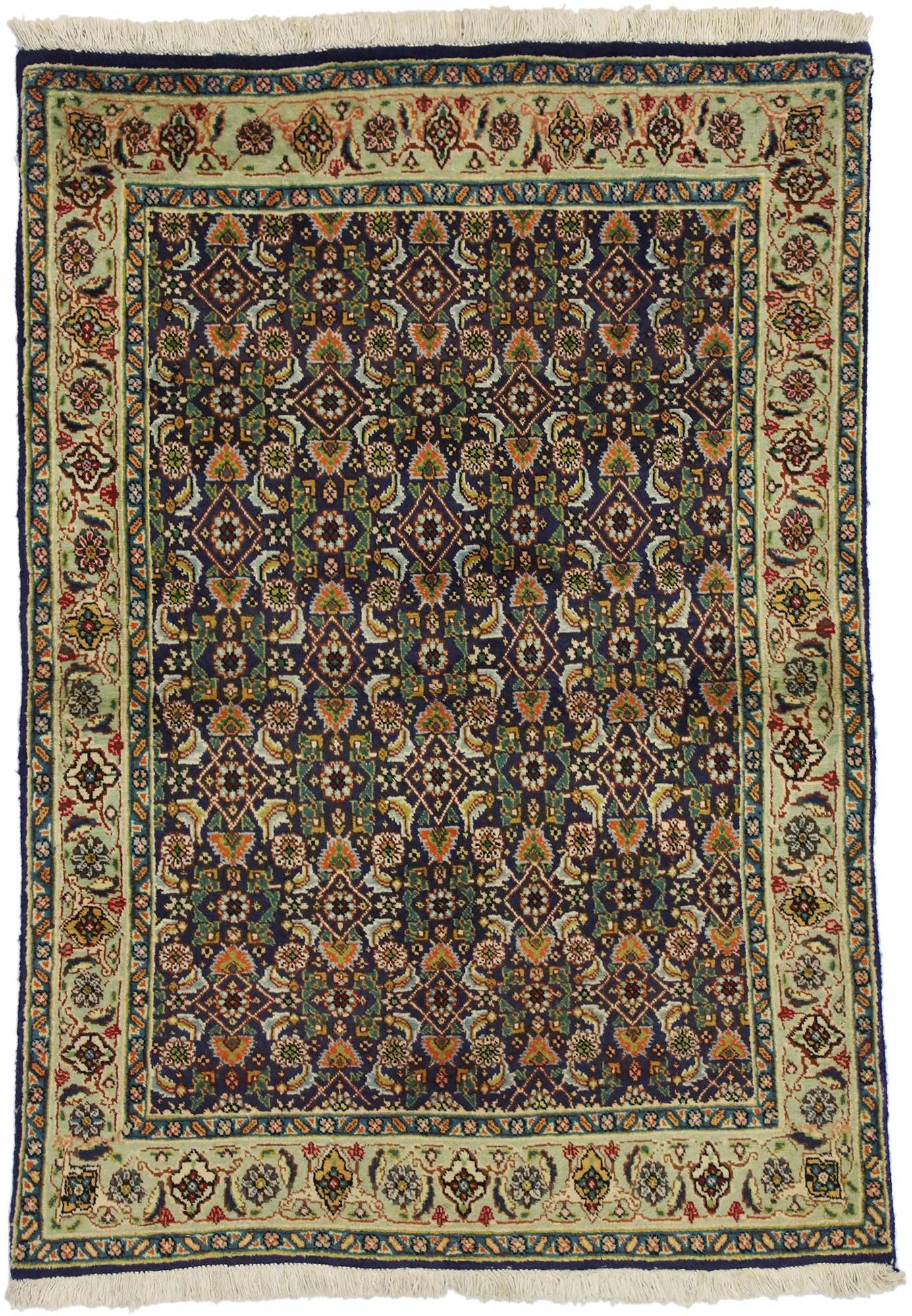 75101 vintage Persian Tabriz rug with traditional style. This hand-knotted wool vintage Persian Tabriz rug features an all-over pattern on a navy blue field surrounded by a classic light green border creating a well-balanced and timeless design.