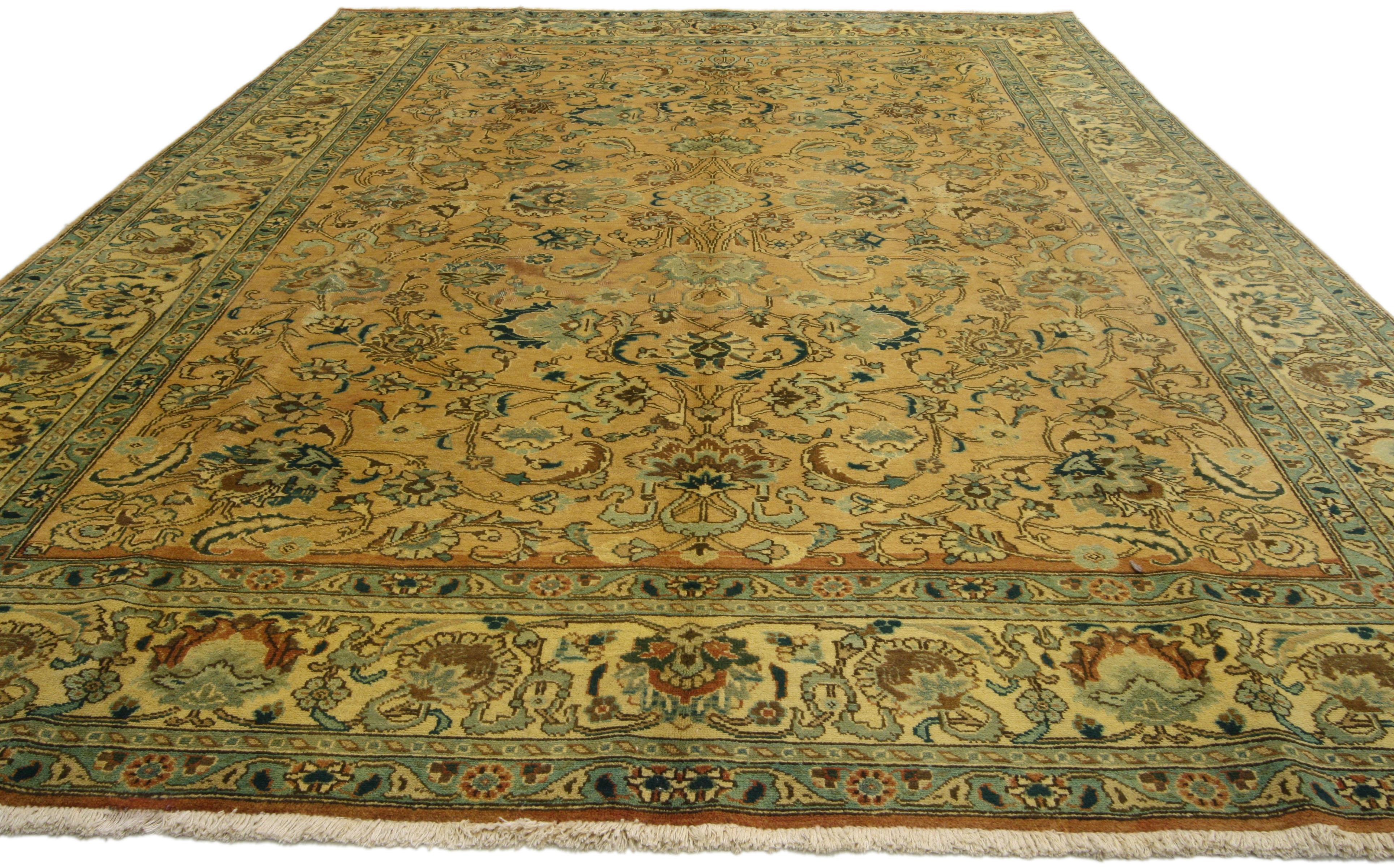 76308, vintage Persian Tabriz rug with traditional style. This hand-knotted wool vintage Persian Tabriz rug features an all-over pattern composed of blooming palmettes, feathers, stylized flowers and arabesque vines surrounded by a classic border