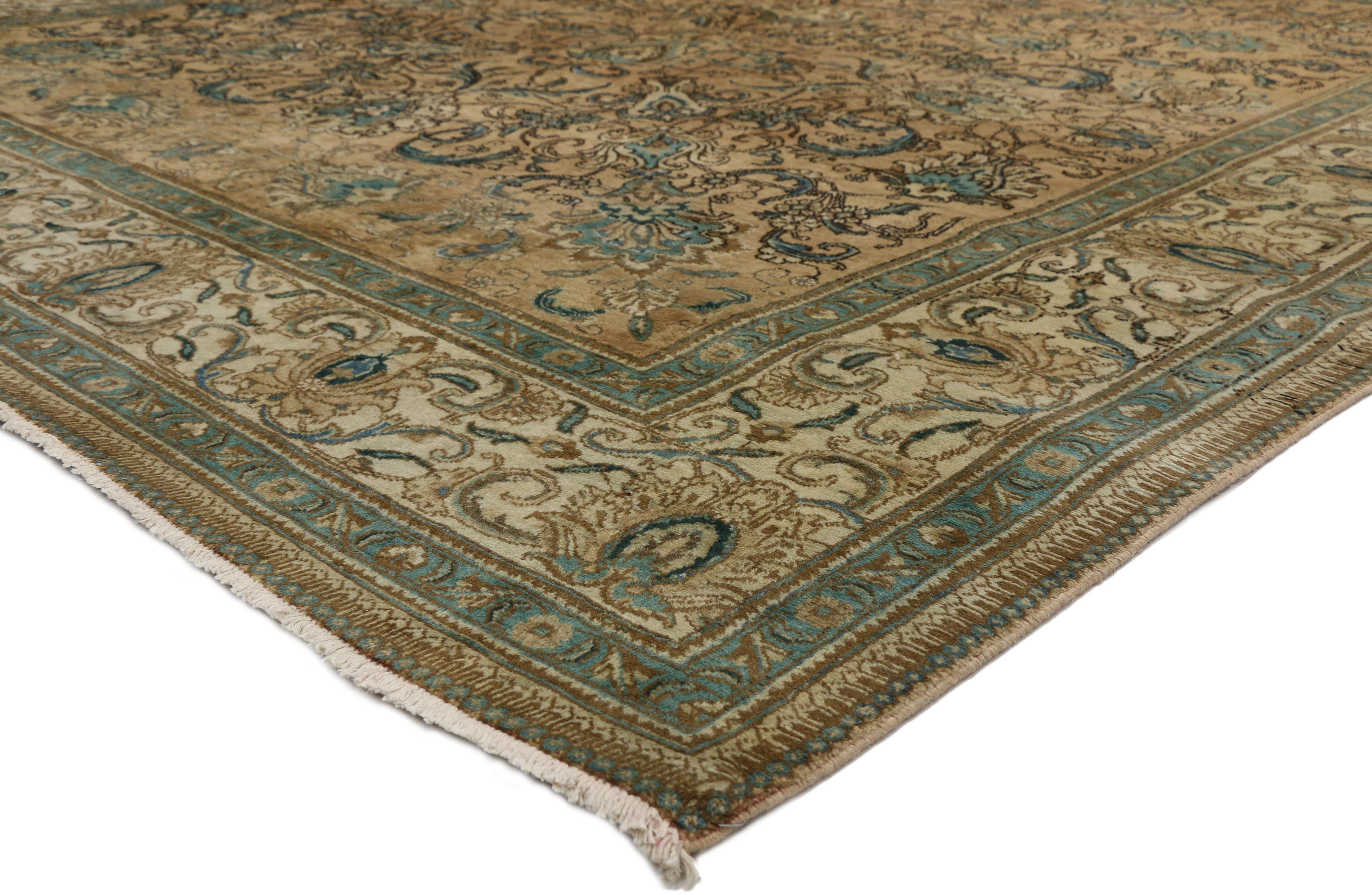 76449 Vintage Persian Tabriz Rug with Romantic Georgian Style 10’00 x 16’00. Regal and refined with a timeless design,this hand-knotted wool vintage Persian Tabriz rug is poised to impress. The abrashed tan colored field beautifully displays an