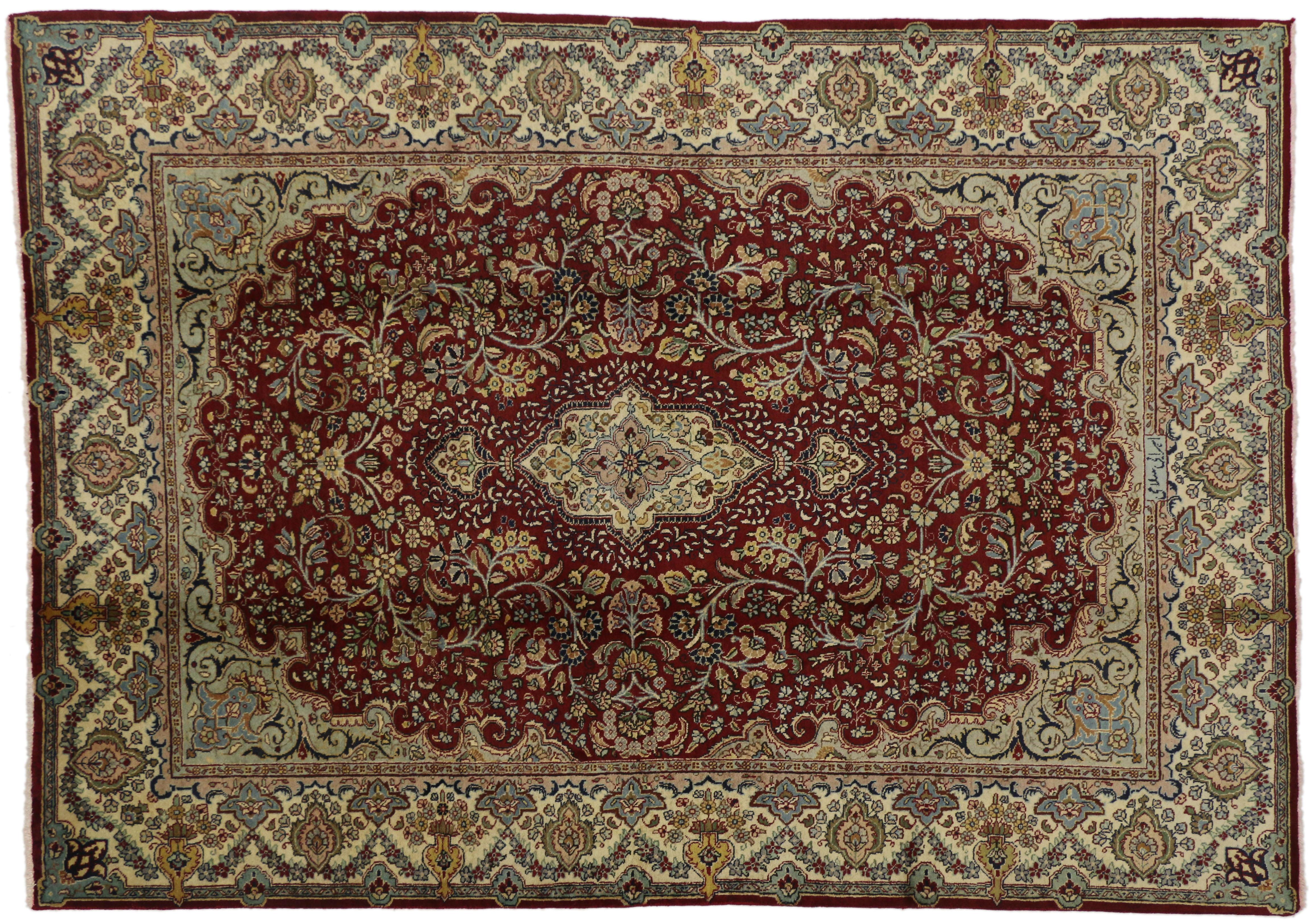 76583, vintage Persian Tabriz rug with traditional style. This hand-knotted wool vintage Persian Tabriz rug features center medallion with an allover pattern surrounded by arabesque spandrels and a classic border creating a well-balanced and