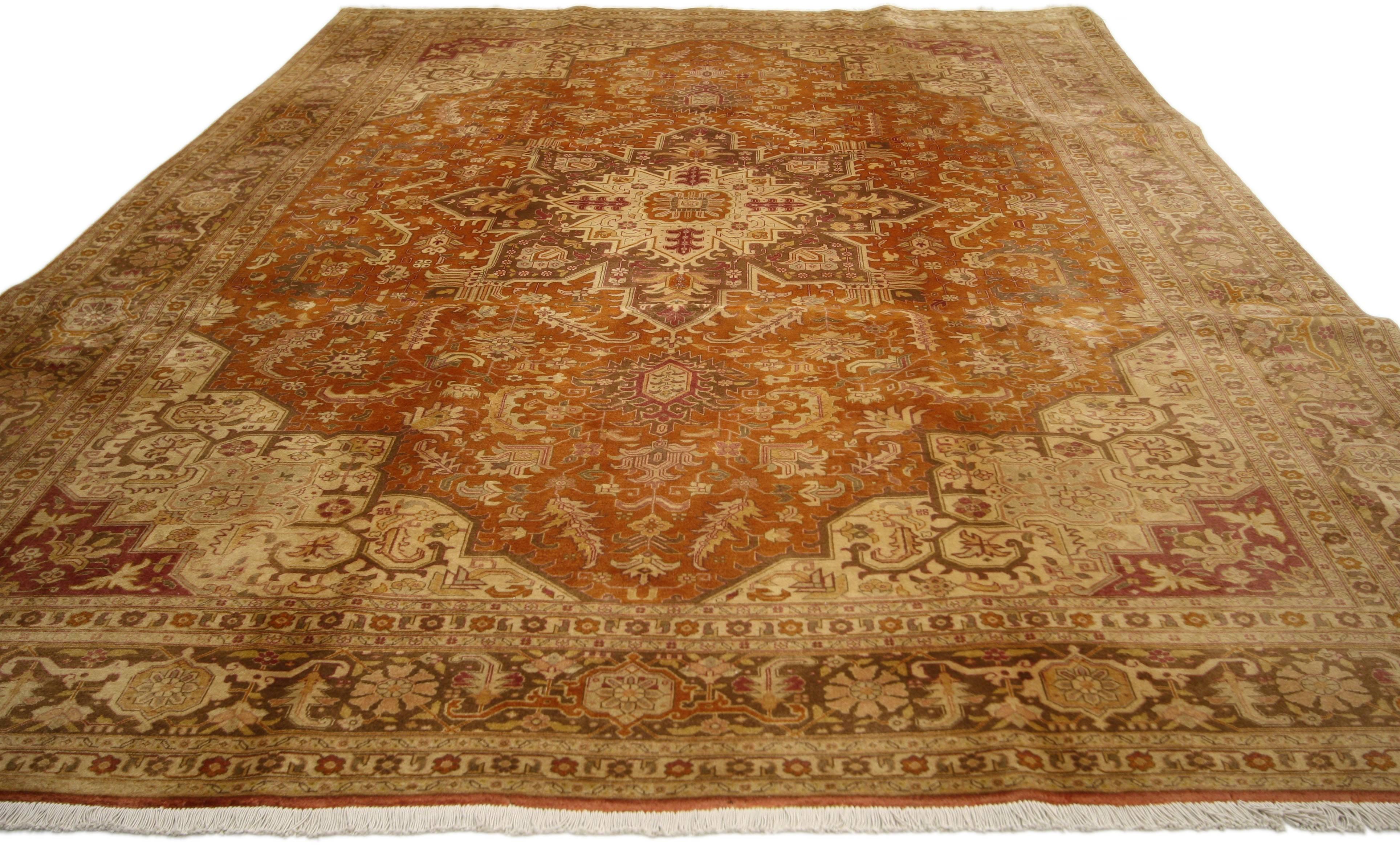 74302, vintage Persian Tabriz rug with traditional style. This hand-knotted wool vintage Persian Tabriz rug features a centre medallion with an all-over geometric pattern surrounded by elaborate spandrels and a Classic border creating a