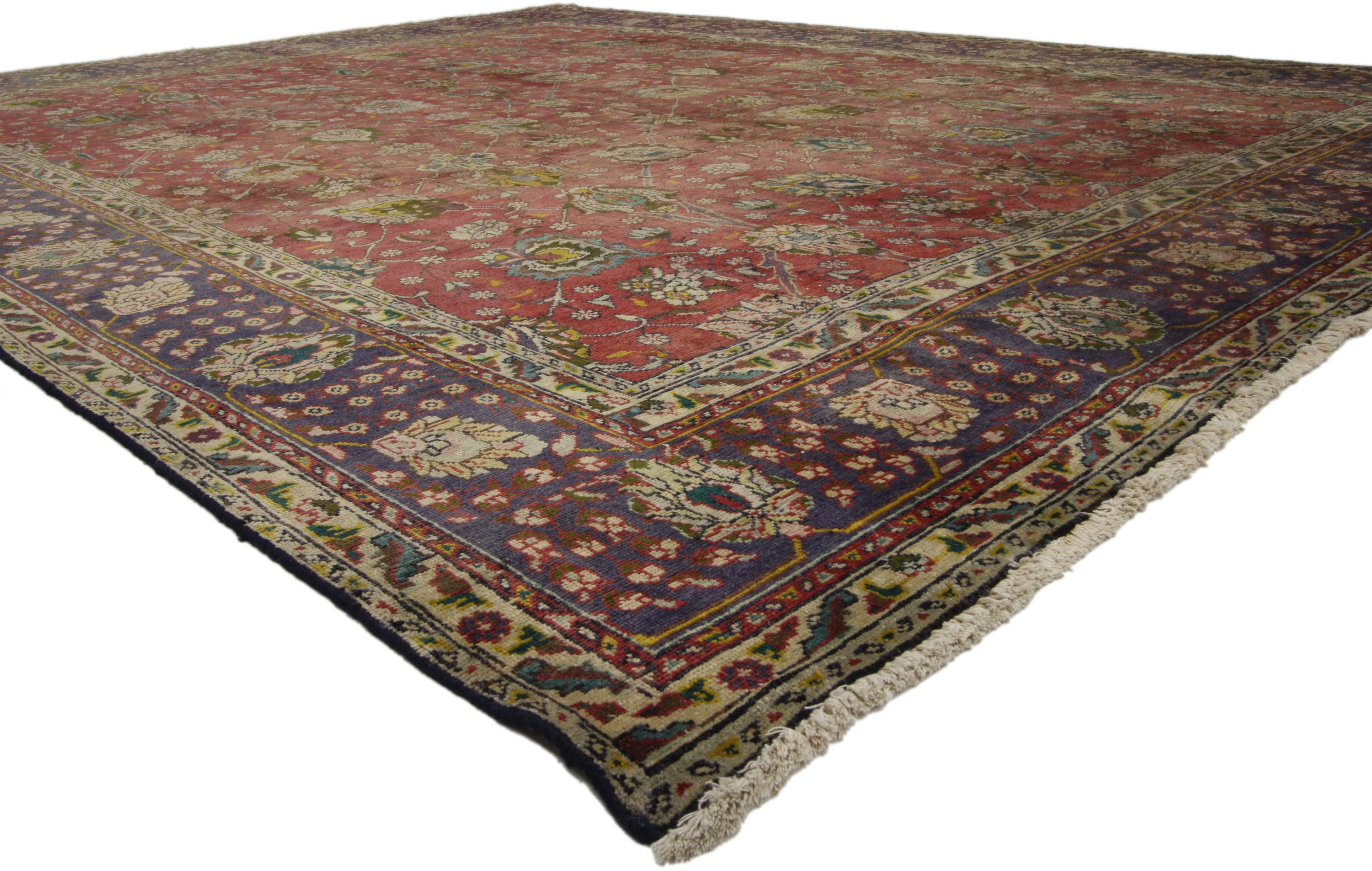 74331 Vintage Persian Tabriz Area Rug with Traditional Colonial and Federal Style. This hand-knotted wool vintage Persian Tabriz rug features an all-over geometric floral pattern composed of blooming palmettes, leafy tendrils, rosettes, and swirling