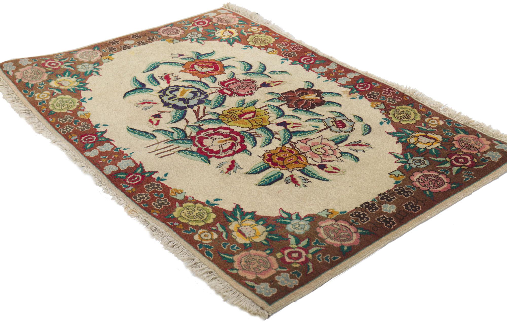 75654 Vintage Persian Tabriz Rug, 01'11 x 02'10. This hand-knotted wool vintage Persian Tabriz rug features a floral bouquet in a creamy vanilla field surrounded by a complementary floral border creating a well-balanced and timeless design. This