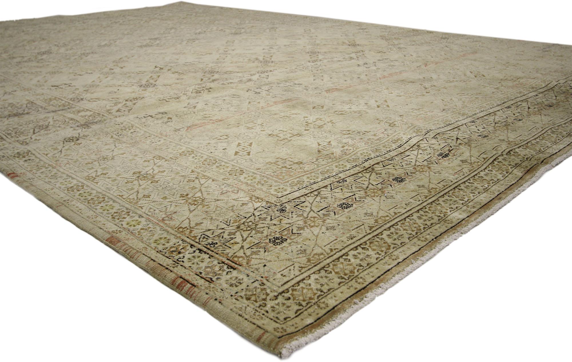 60689, vintage Persian Tabriz rug with warm, neutral colors. Timeless style and geometric ornaments based on traditional Islamic tile artwork design meld together beautifully in this hand knotted wool vintage Persian Tabriz rug. Warm, neutral
