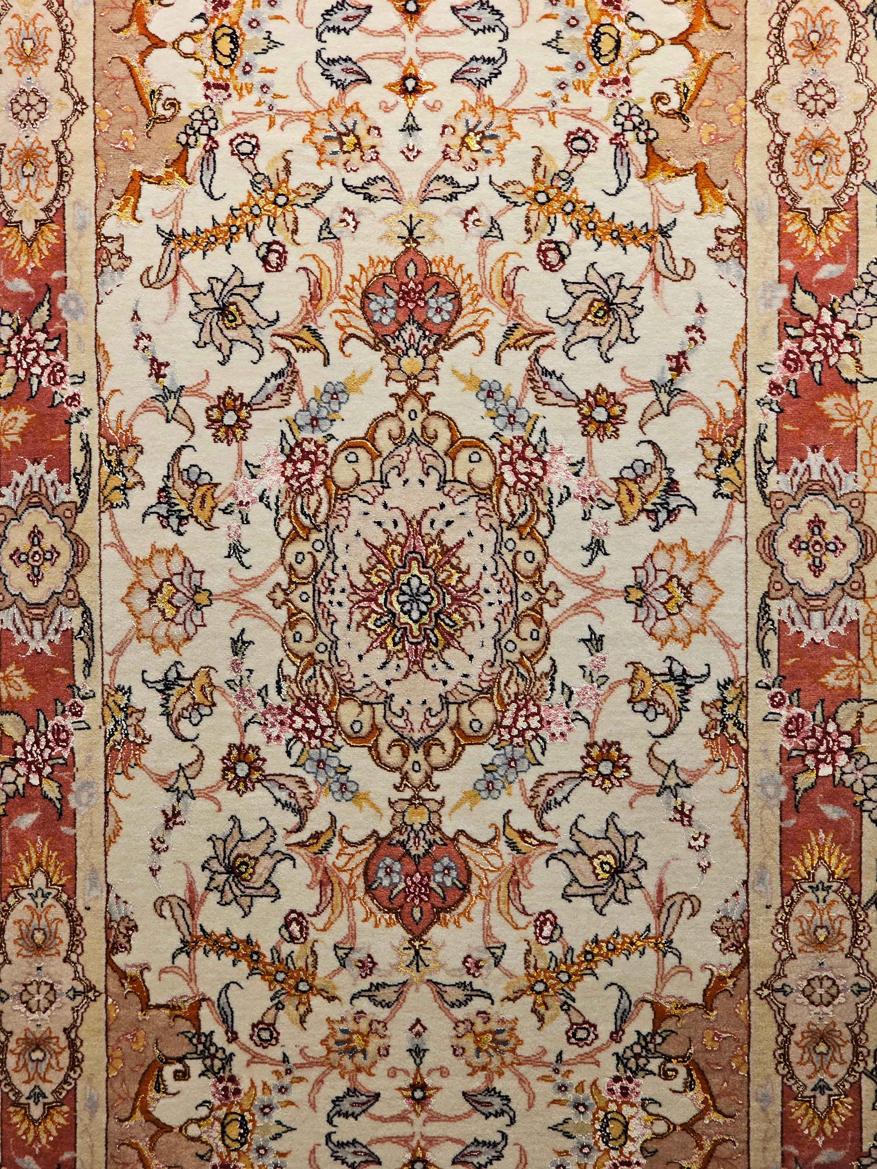 The Tabriz runner with a floral design has a wool pile on a cotton foundation with silk highlights.  It has an excellent weave in a cream color field and a red border. The use of silk to highlight the flowers provides a shimmering effect when the