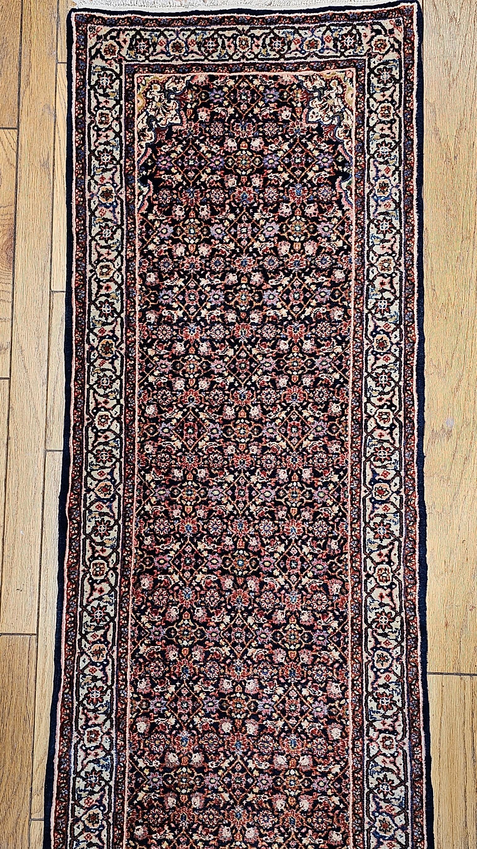This exquisite vintage Persian Tabriz long runner, dating to the mid-1900s, showcases the timeless beauty of traditional craftsmanship. Featuring a richly detailed all-over Herati pattern, the runner is centered with a subtle single medallion—an