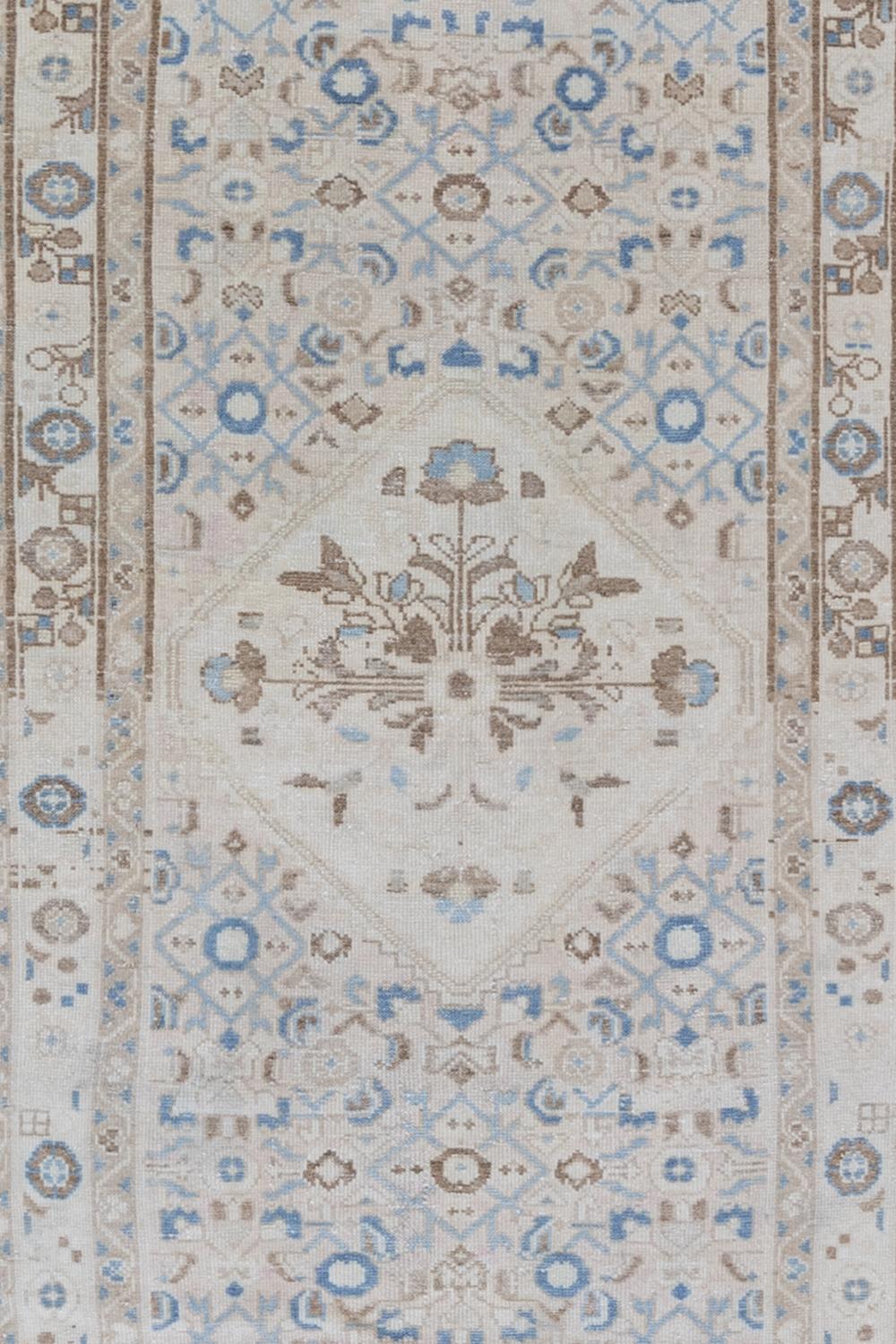 Age: Circa 1940

Colors: ivory, cream, tan, blue

Pile: low

Wear Notes: 2

Material: wool on cotton

Vintage Persian runner woven in the middle of the century. Safe for high traffic areas. 

Vintage and antique rugs are by nature,
