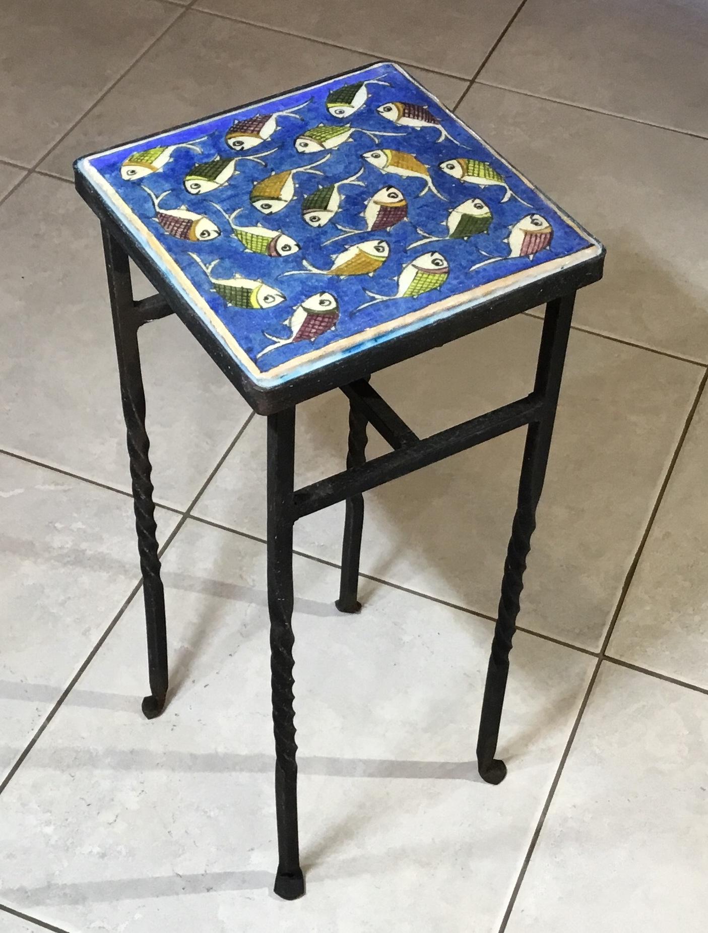 Elegant side table made of ceramic Persian tile top hand-painted and glazed of wondering school of fish on a beautiful blue background the base of the table made of iron with four hand twisted legs, very decorative and functional side table ,and