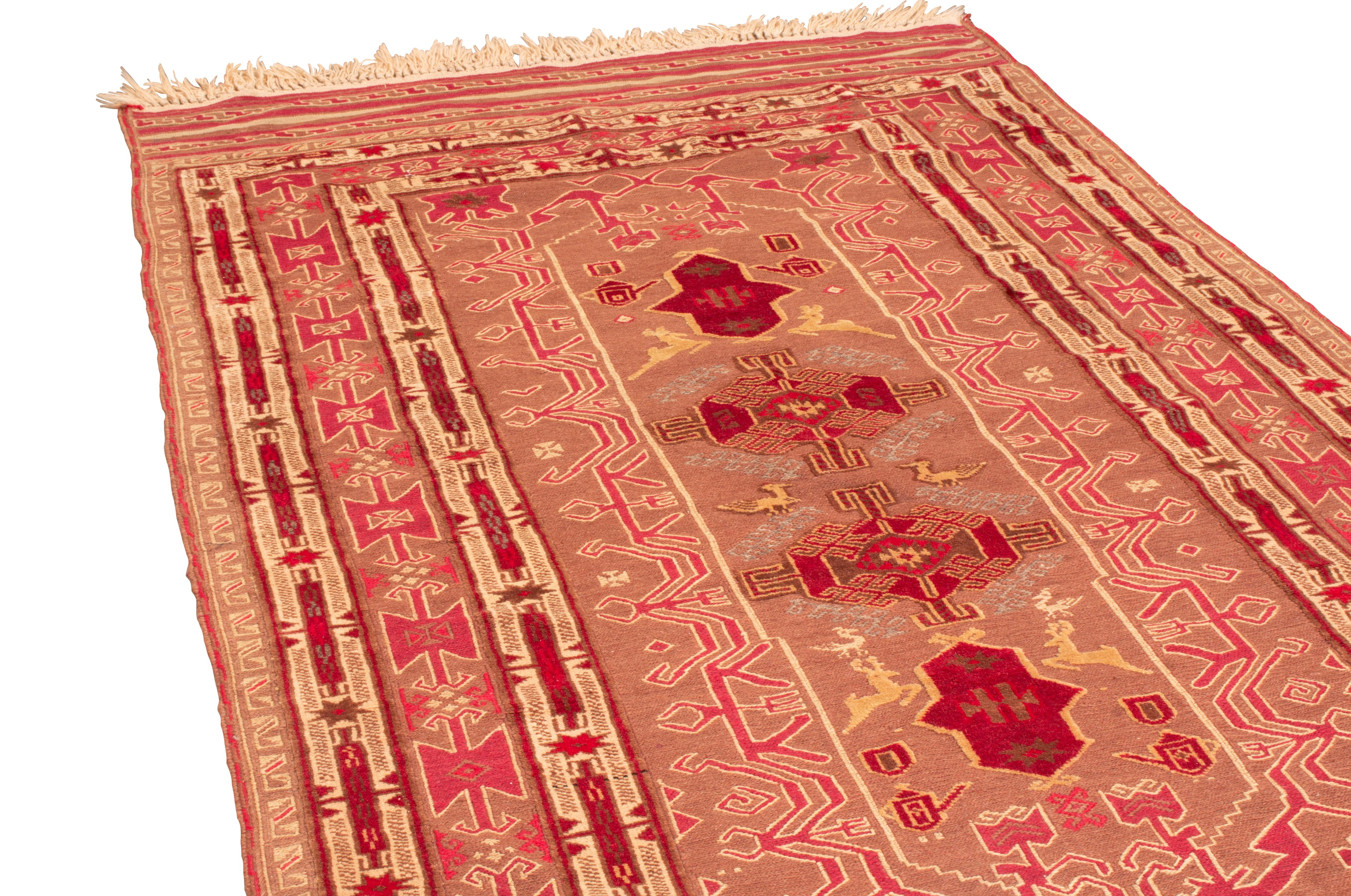 Originating from Persia in 1960, this vintage transitional Persian kilim rug features several lesser-known animal symbols celebrated among its kind. Flat woven in tight, durable wool, between the ornate crimson red, brown, and beige-golden field
