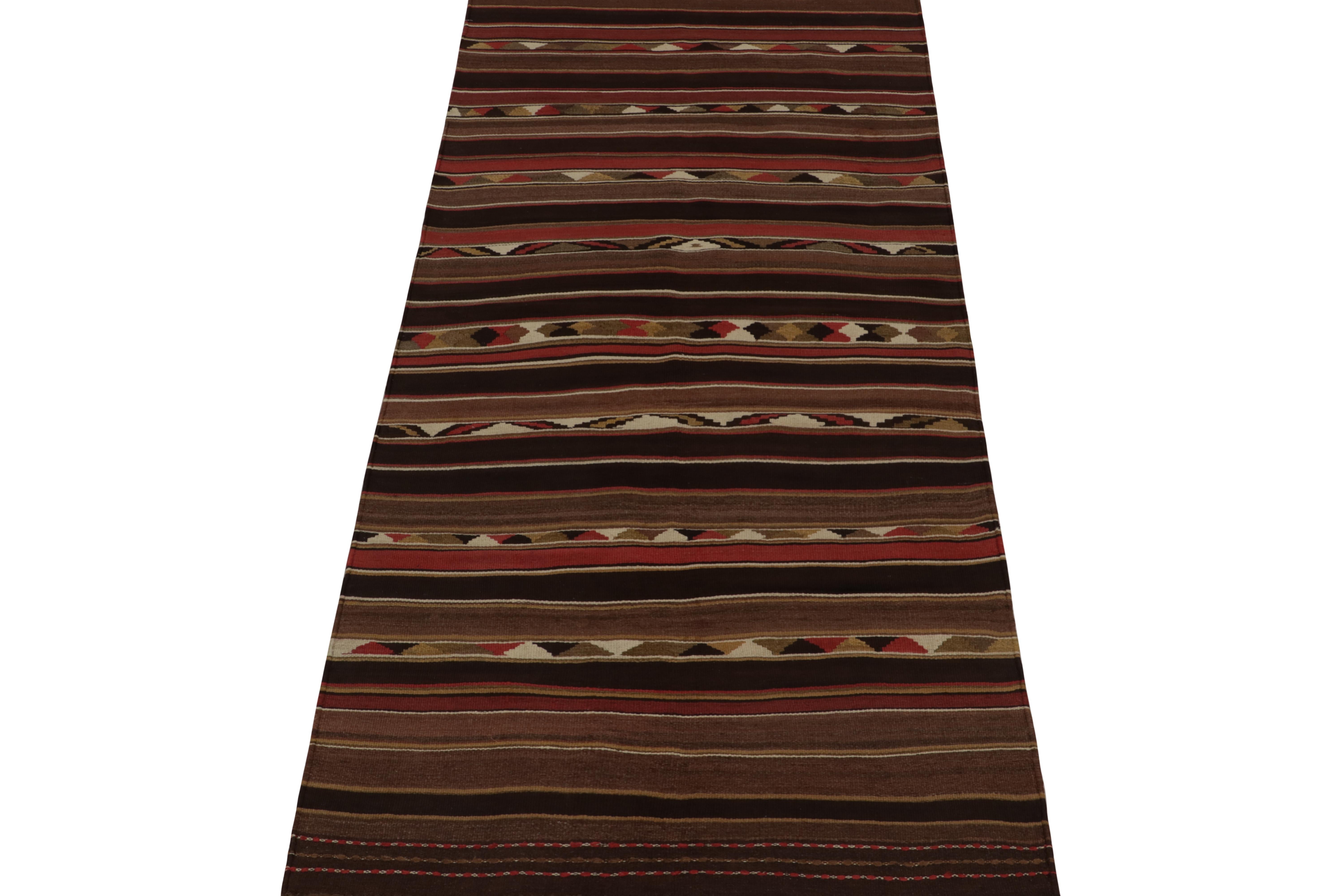 This vintage 4x9 Persian kilim is a tribal gallery—handwoven in wool circa 1950-1960.

Further on the Design:

This simple design has subtle intricacies in its play of stripes and geometry patterns with rich and bright colors alike. Keen eyes will