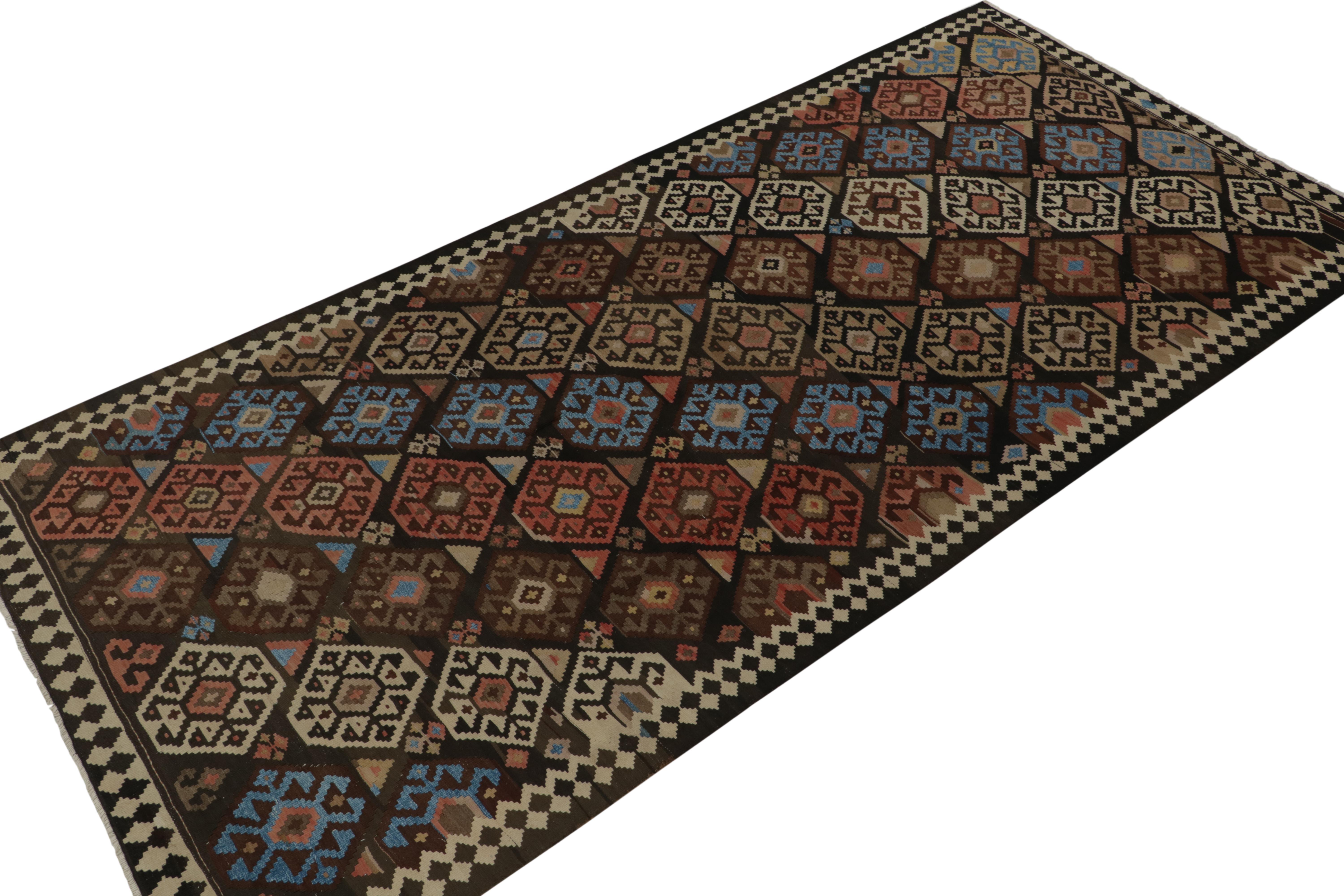 This vintage 6x13 Persian kilim is handwoven in all wool, and originates circa 1950-1960.

Further on the Design:

The design prefers brown tones with brick red, beige, and bright blue accents in diagonal rows of geometric patterns. Keen eyes will