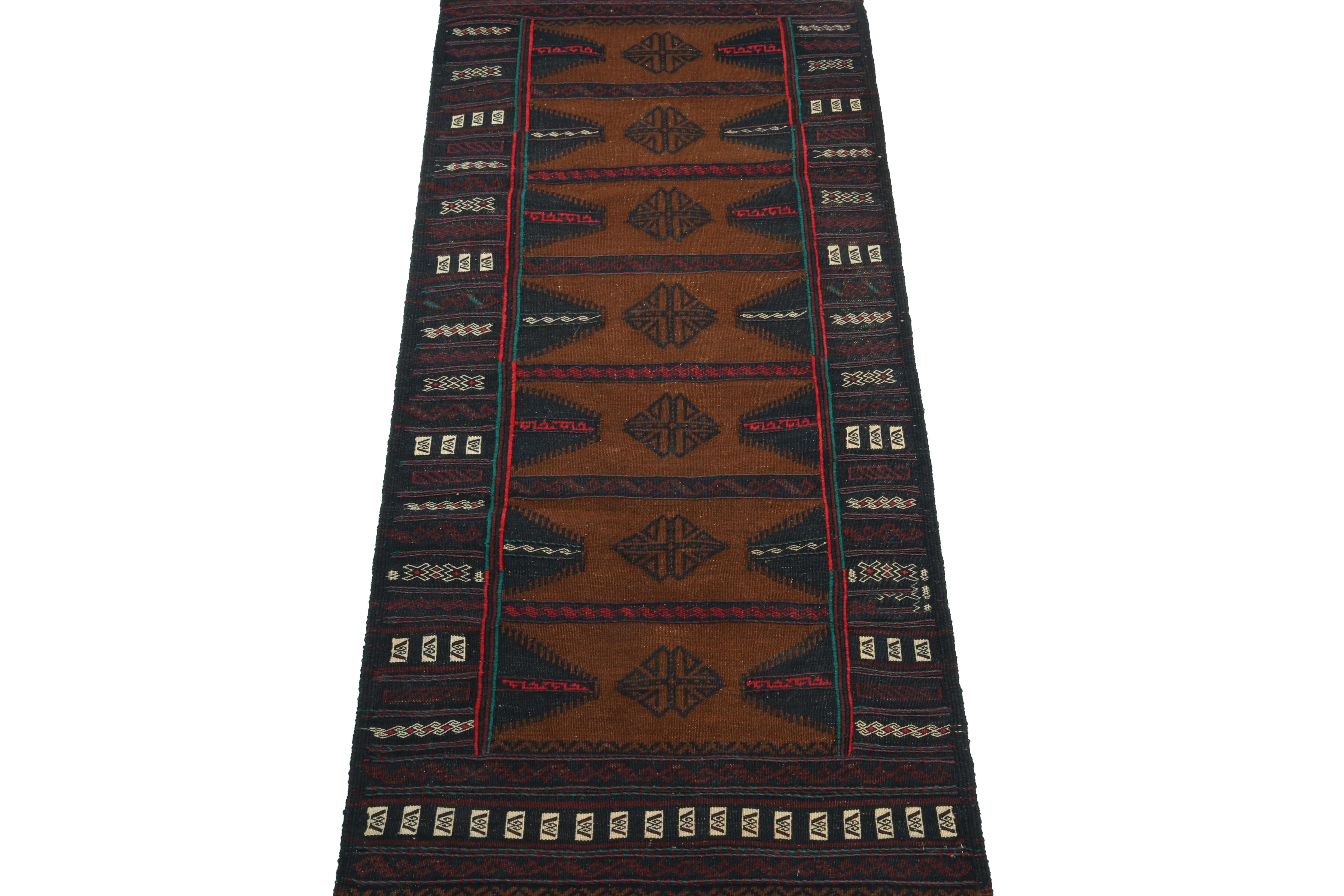 This vintage 3x5 Persian kilim rug is handwoven in wool, and originates circa 1950-1960.

Further on the Design:

The design prefers a brown open field with navy borders and vibrant red and teal accents in its medallions and geometric patterns.