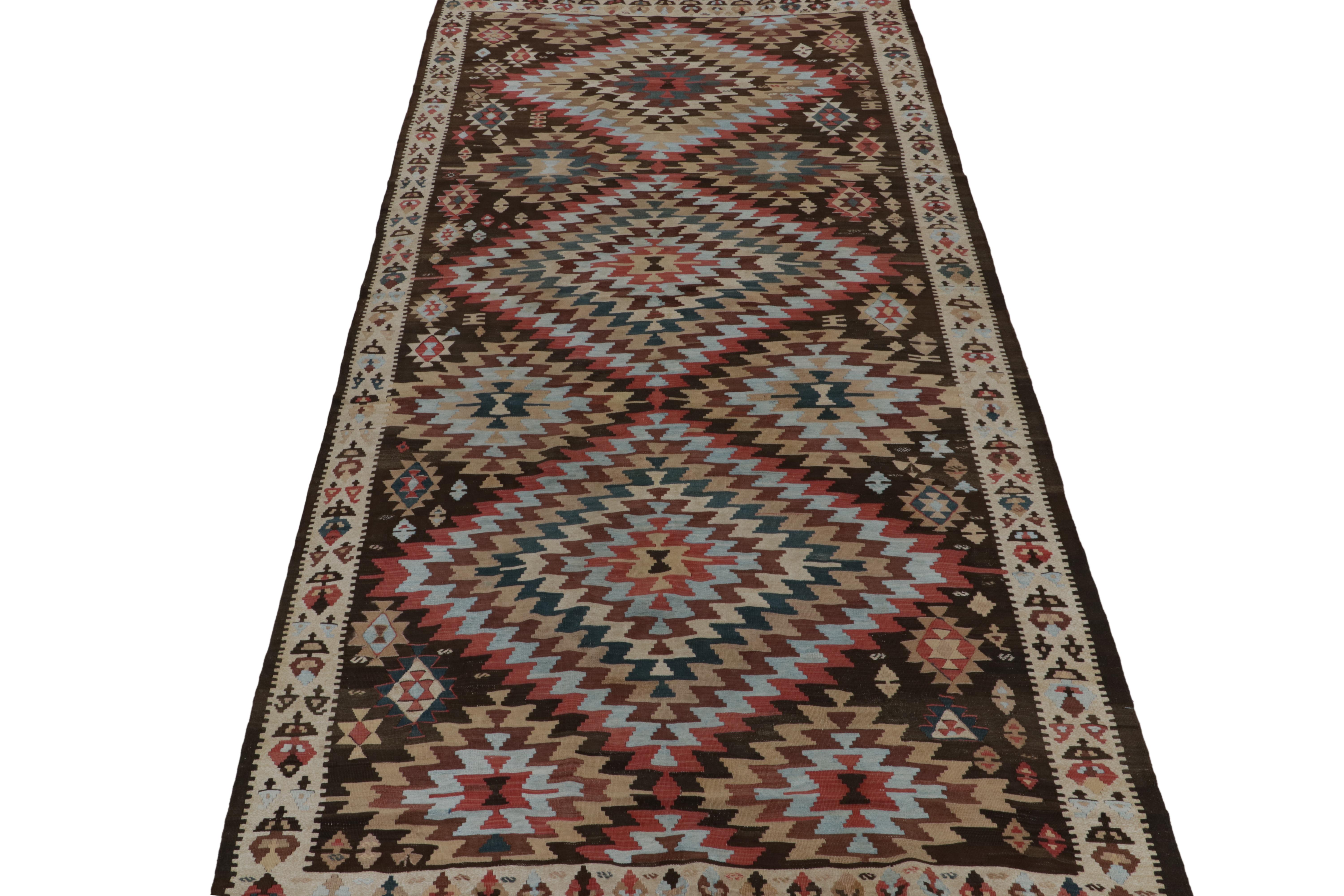 This vintage 6x11 Persian kilim is a meticulously detailed tribal rug—handwoven in wool circa 1950-1960.

Further on the Design:

This polychromatic medallion design prefers chocolate brown, beige, brick red and sky blue in its graphic play of rich