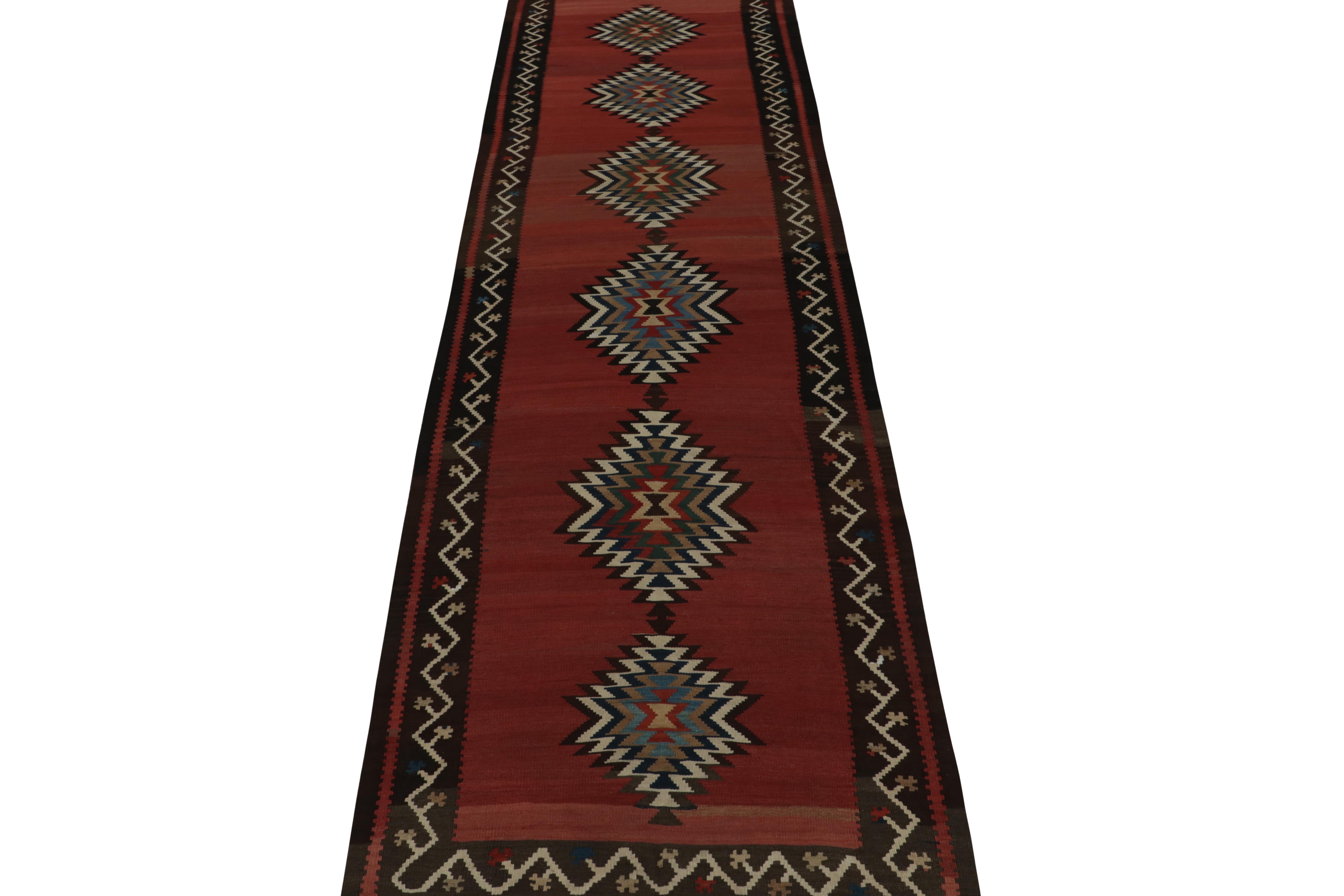 This vintage 4x14 Persian kilim is a tribal gallery runner—handwoven in wool, it’s believed to originate circa 1950-1960. 

Further on the Design:

The design prefers multicolor medallions on a red open field, wrapped in rich brown and off-white