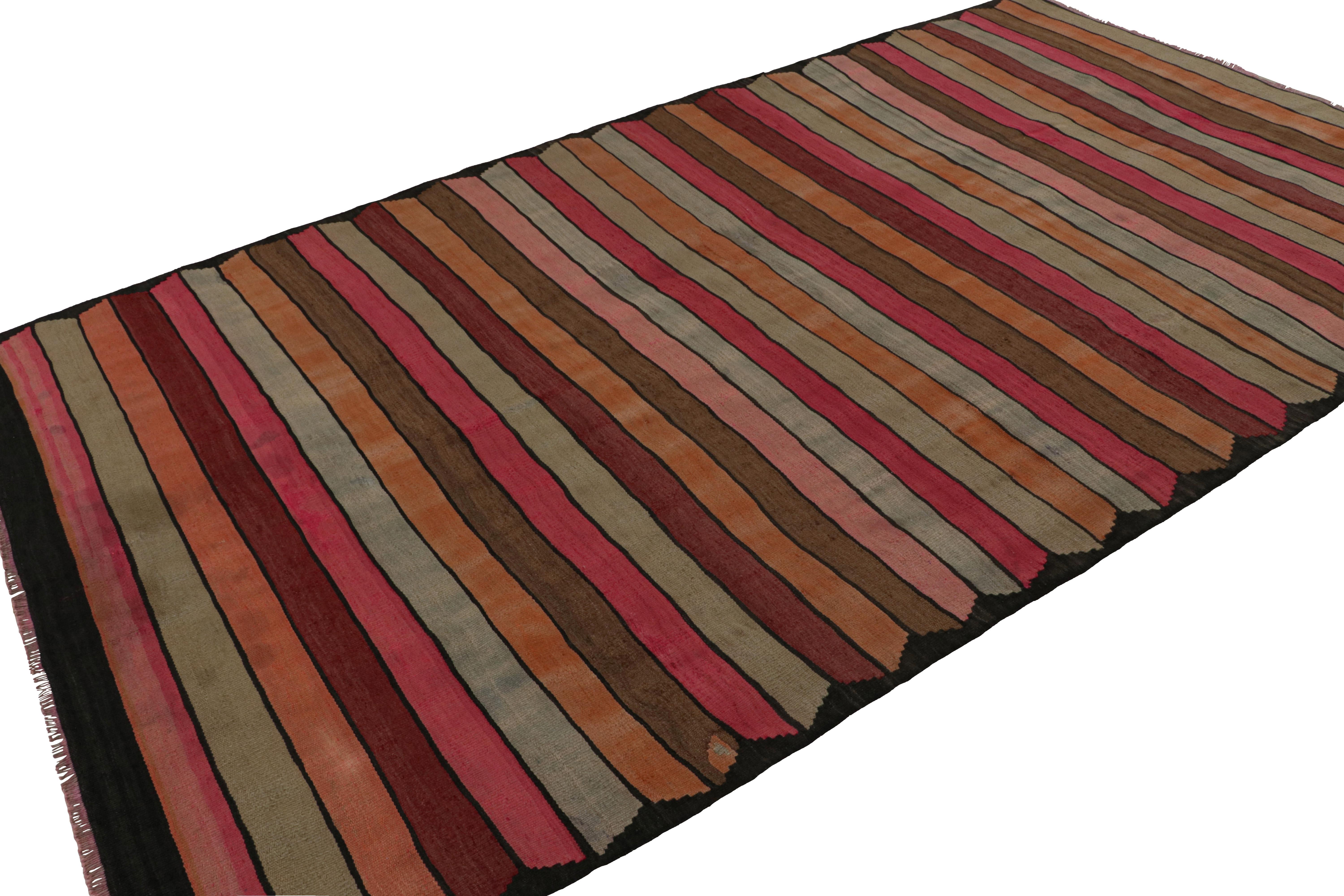 Featuring a play of colorful stripes in pink, orange, beige/brown and blue, this 6x9 vintage Persian tribal kilim rug, handwoven in wool, circa 1950-1960, portrays most likely a Northwest design. 

On the Design: 

Admirers of craft may note this