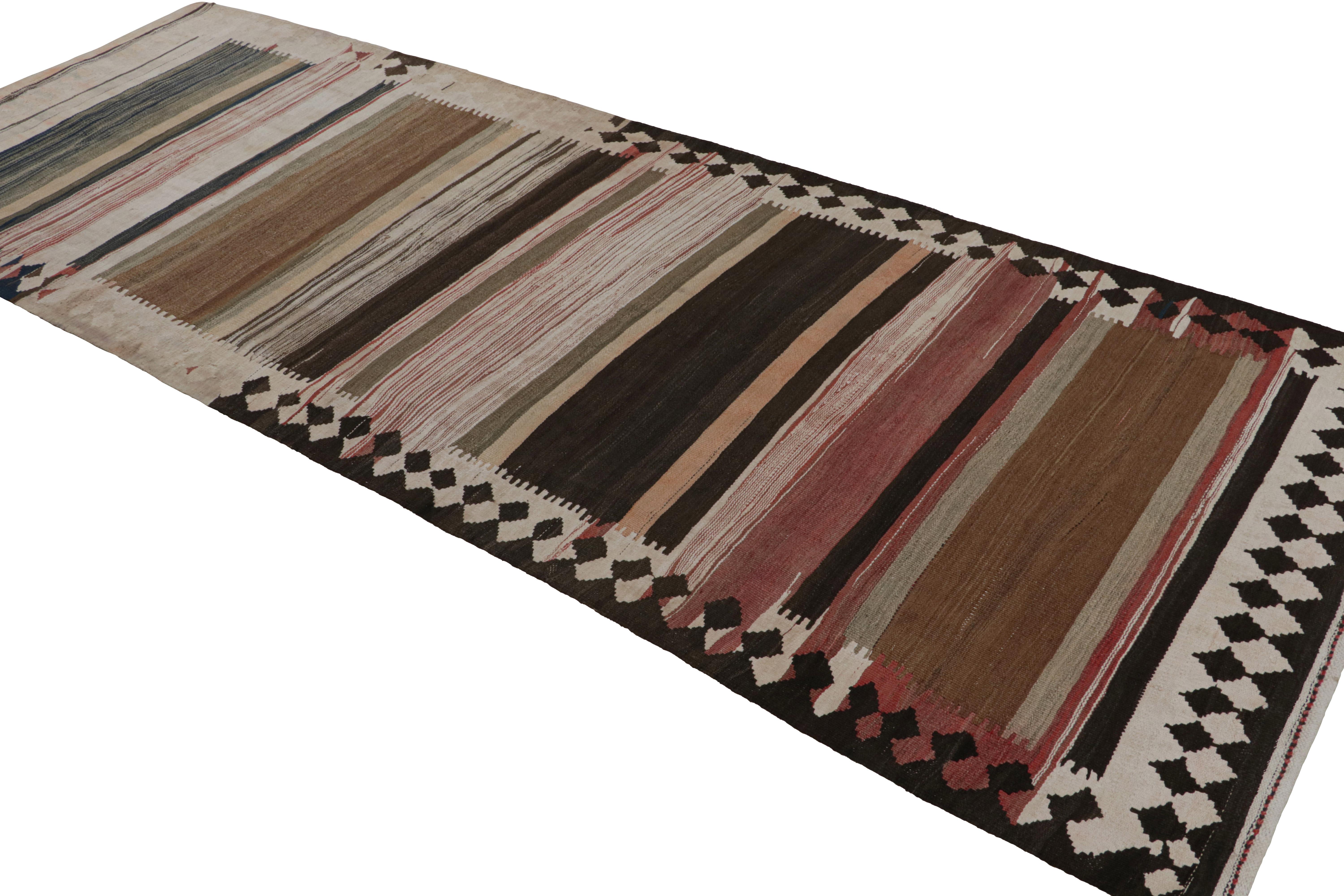 Featuring a colorway of Beige/brown, black, pink, and silver/gray, this 4x10 vintage Persian tribal kilim rug, handwoven in wool, circa 1950-1960, is a playful departure from other striped pieces of its period. 

On the Design: 

As a distinct