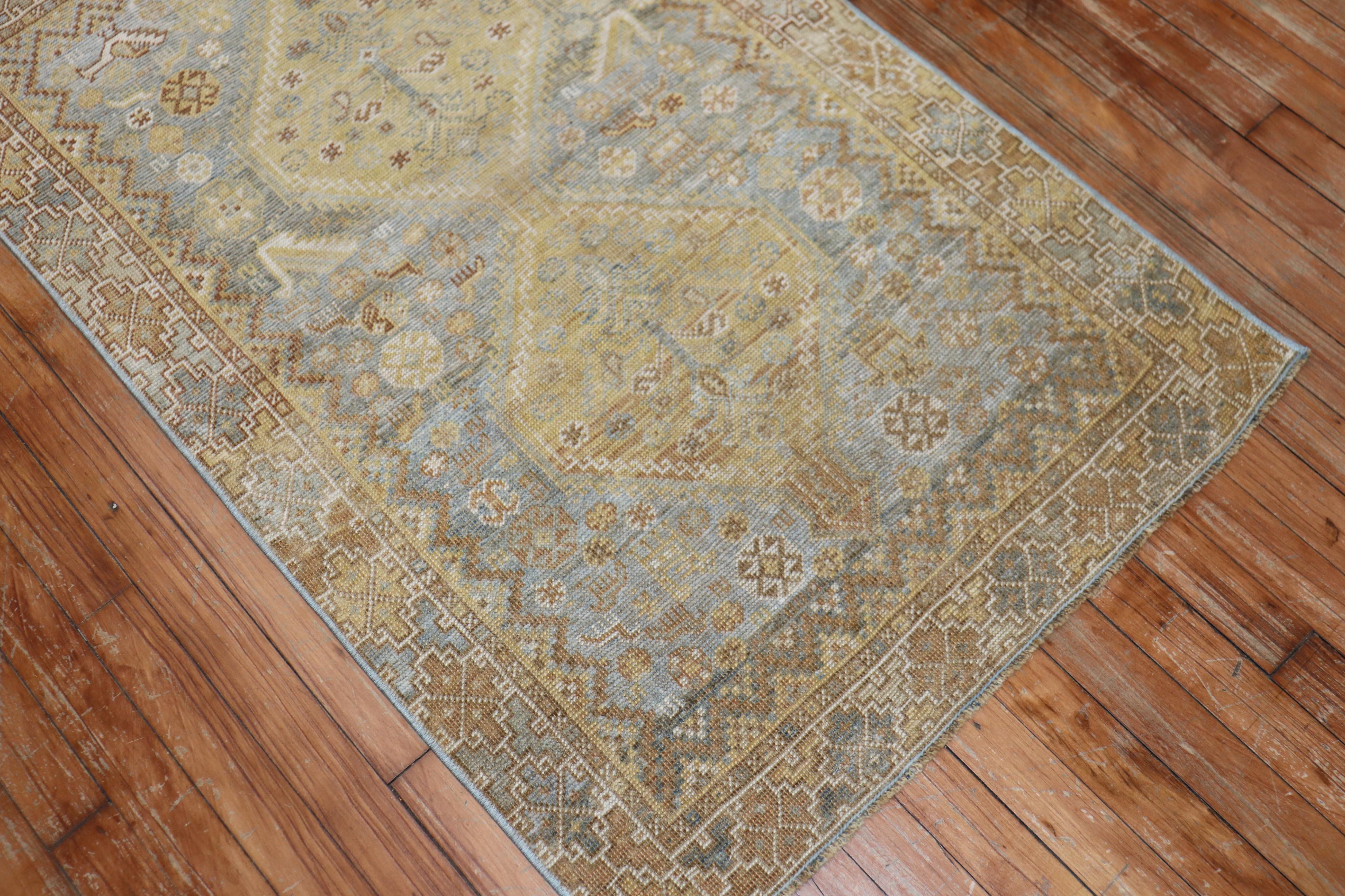 an early 20th Century Persian Tribal Shiraz Rug with yellow and brown accents on a light blue field

Measures: 2'7'' x 4'1''.