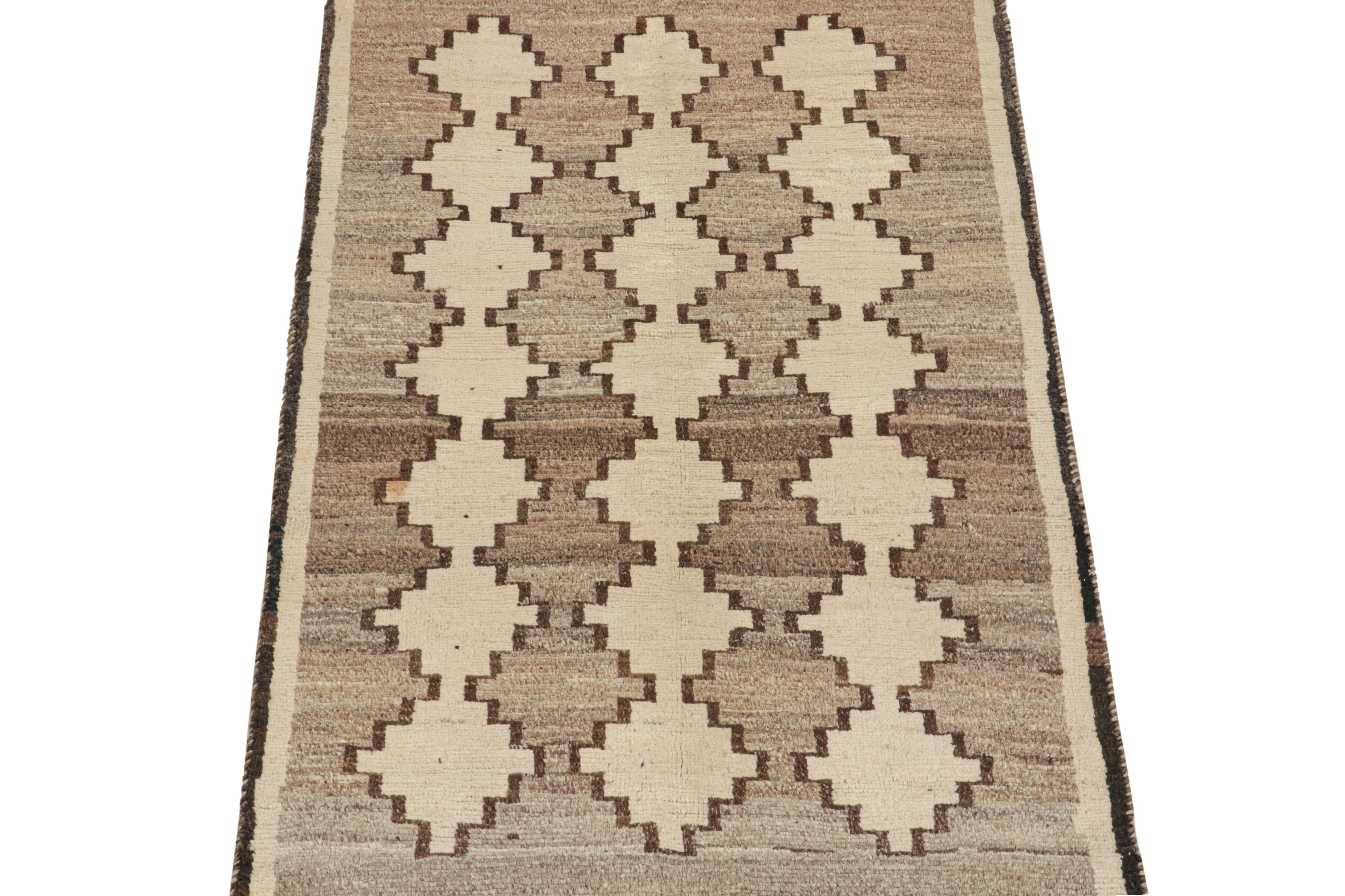This vintage 4x6 Persian rug is a mid-century tribal piece, hand-knotted in wool circa 1950-1960.

Its design enjoys neutral tones in a beige-gray field with off-white geometric patterns and a rich brown border. Pieces like this represent the work