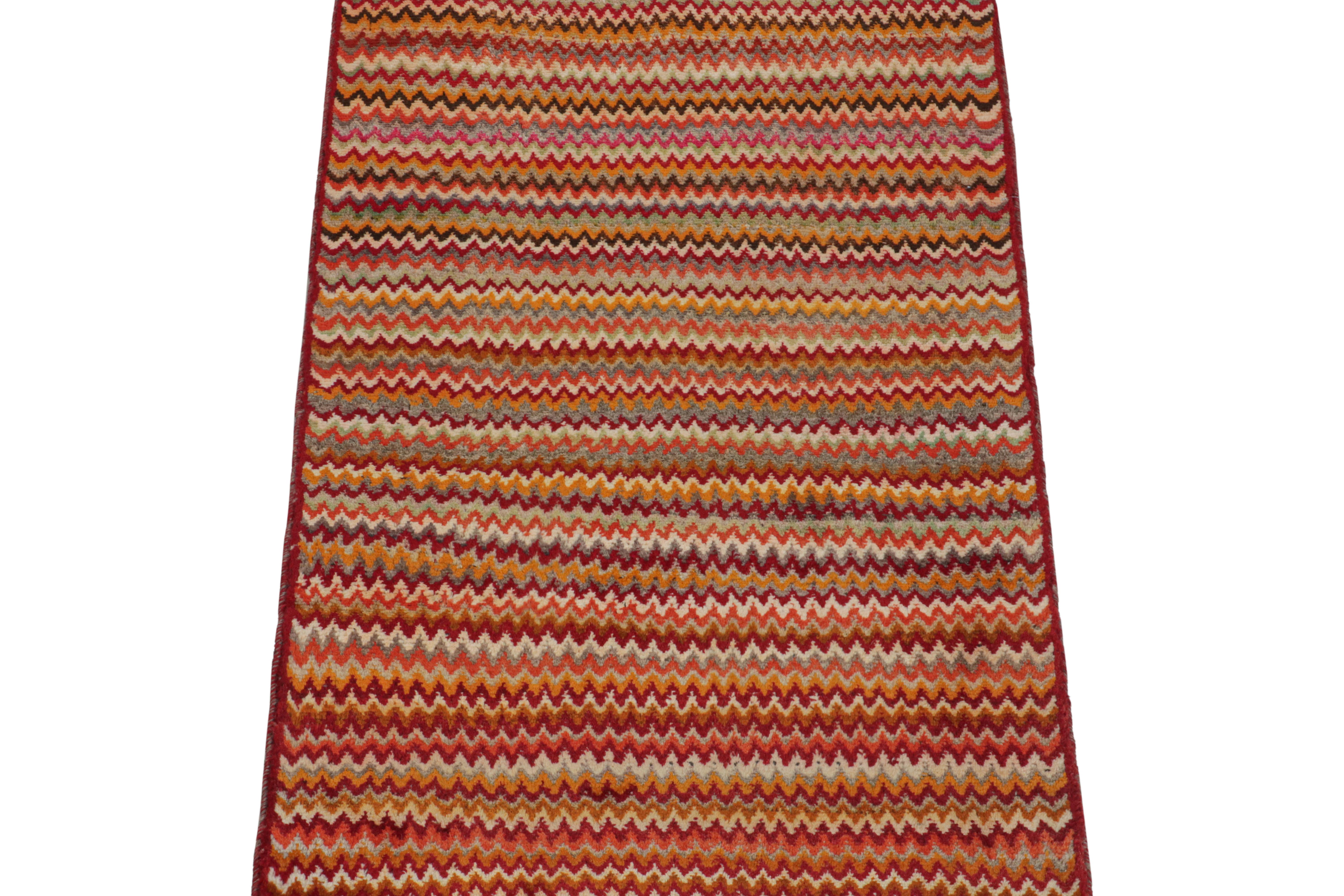This vintage 3x5 Persian rug is a mid-century tribal piece, hand-knotted in wool circa 1950-1960.

Its design enjoys polychromatic chevron patterns with vibrant, warm colors like the red and gold in its many hues. Pieces like this represent the