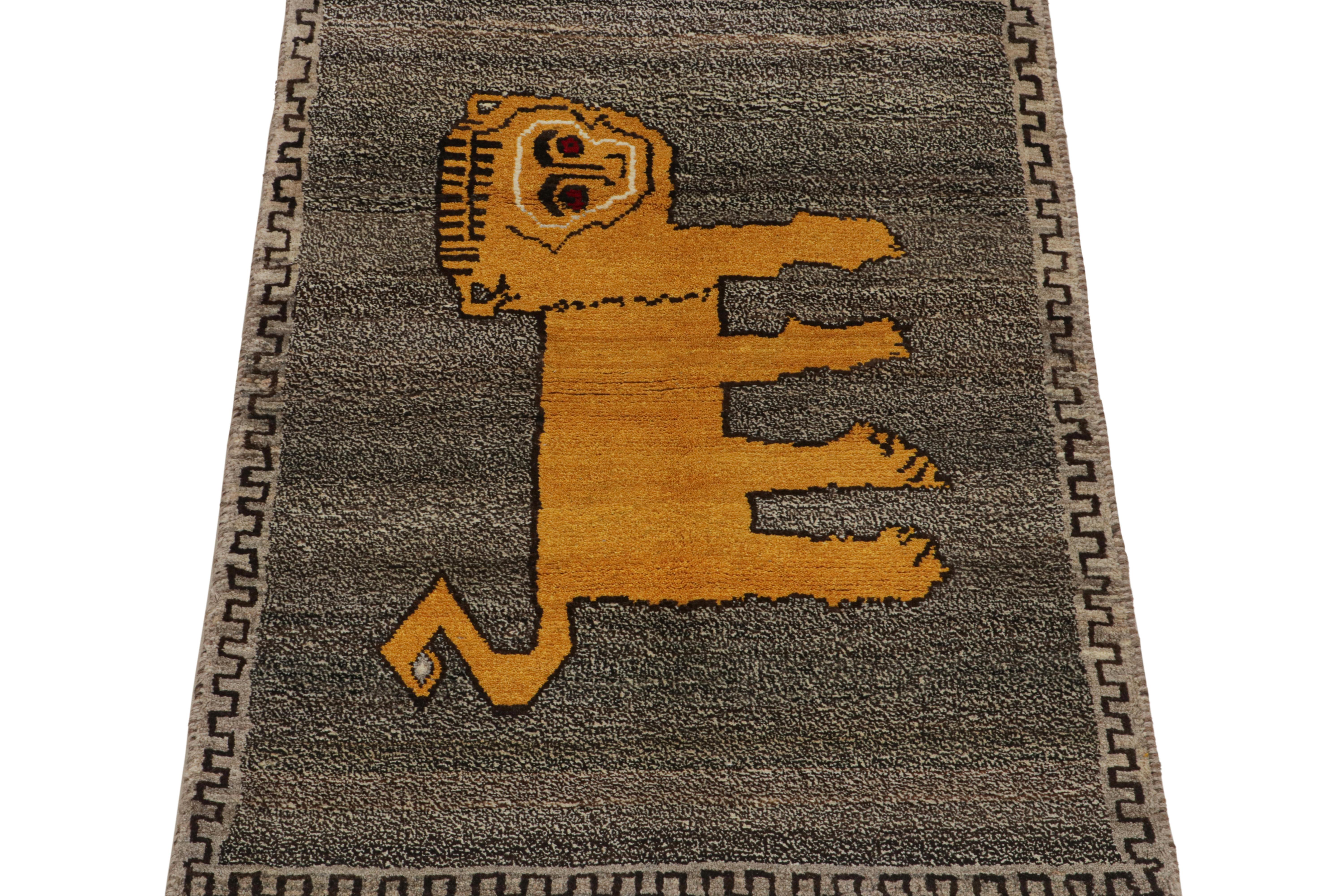 This vintage 3x5 Persian rug is a rare mid-century tribal piece, hand-knotted in wool circa 1950-1960.

Its design enjoys a gold pictorial pattern that resembles a minimalist lion depiction—centered in a beige-brown field with taupe notes.
