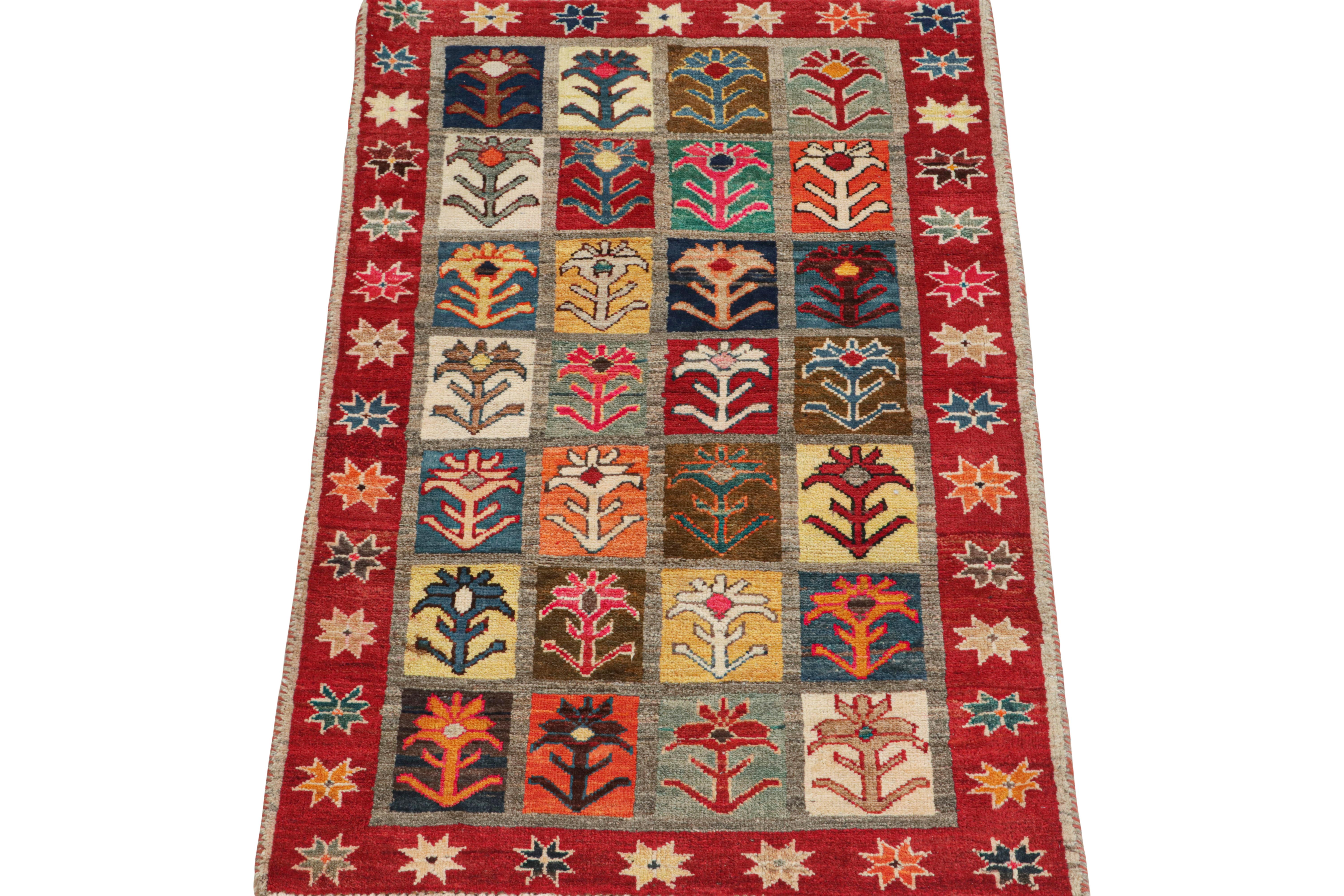 This vintage 3x5 Persian rug is a Gabbeh rug that originates from the Qashqai tribe—hand-knotted in wool circa 1950-1960.

Its design hosts a variety of primitivist geometric patterns—floral motifs in the field and stars in the red border. Though