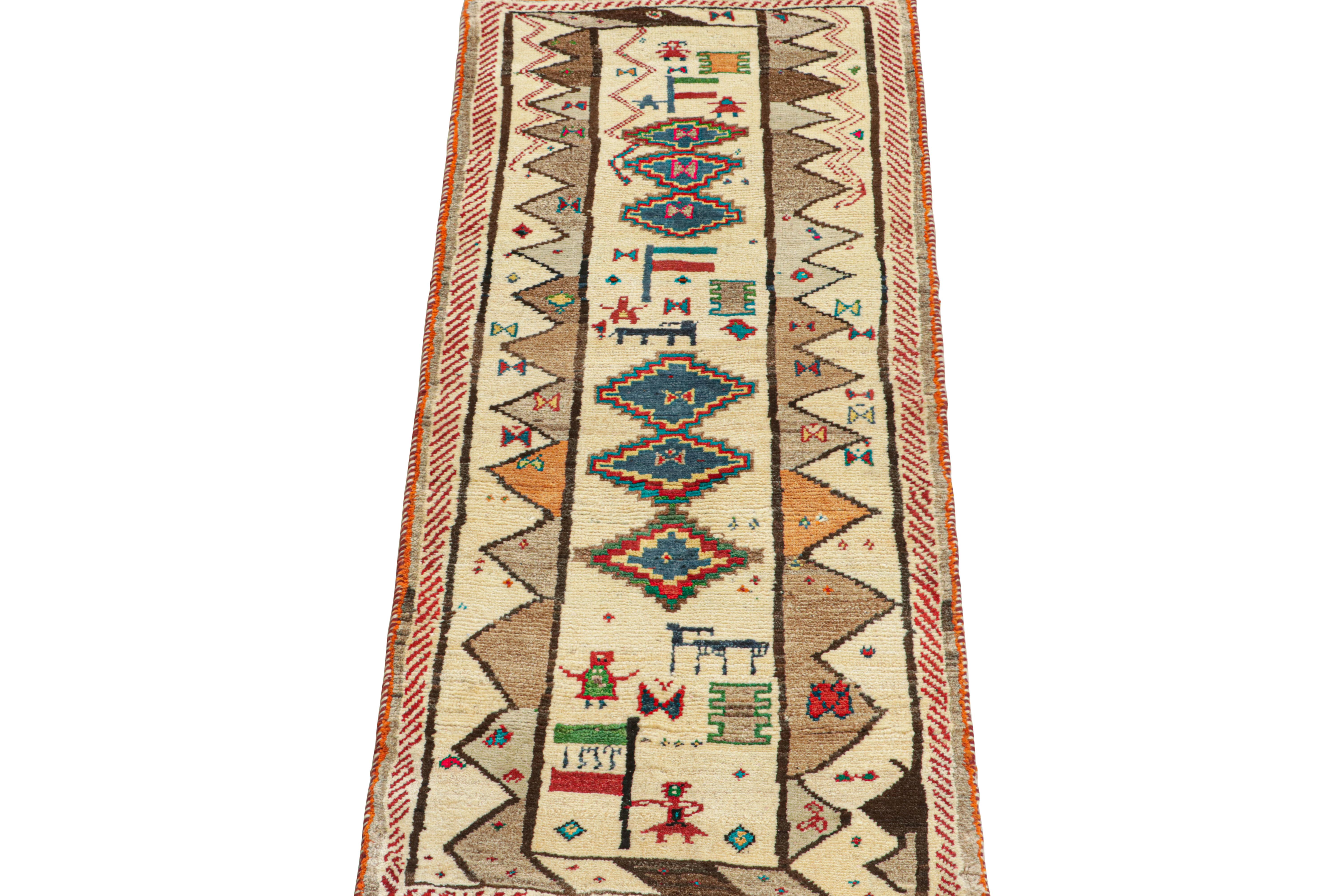 This vintage 2x6 Persian tribal runner is hand-knotted in wool, and originates circa 1950-1960.

Further on the Design:

The design enjoys a beige field and medallion patterns in navy blue with vibrant accent colors. Keen eyes will admire pictorial