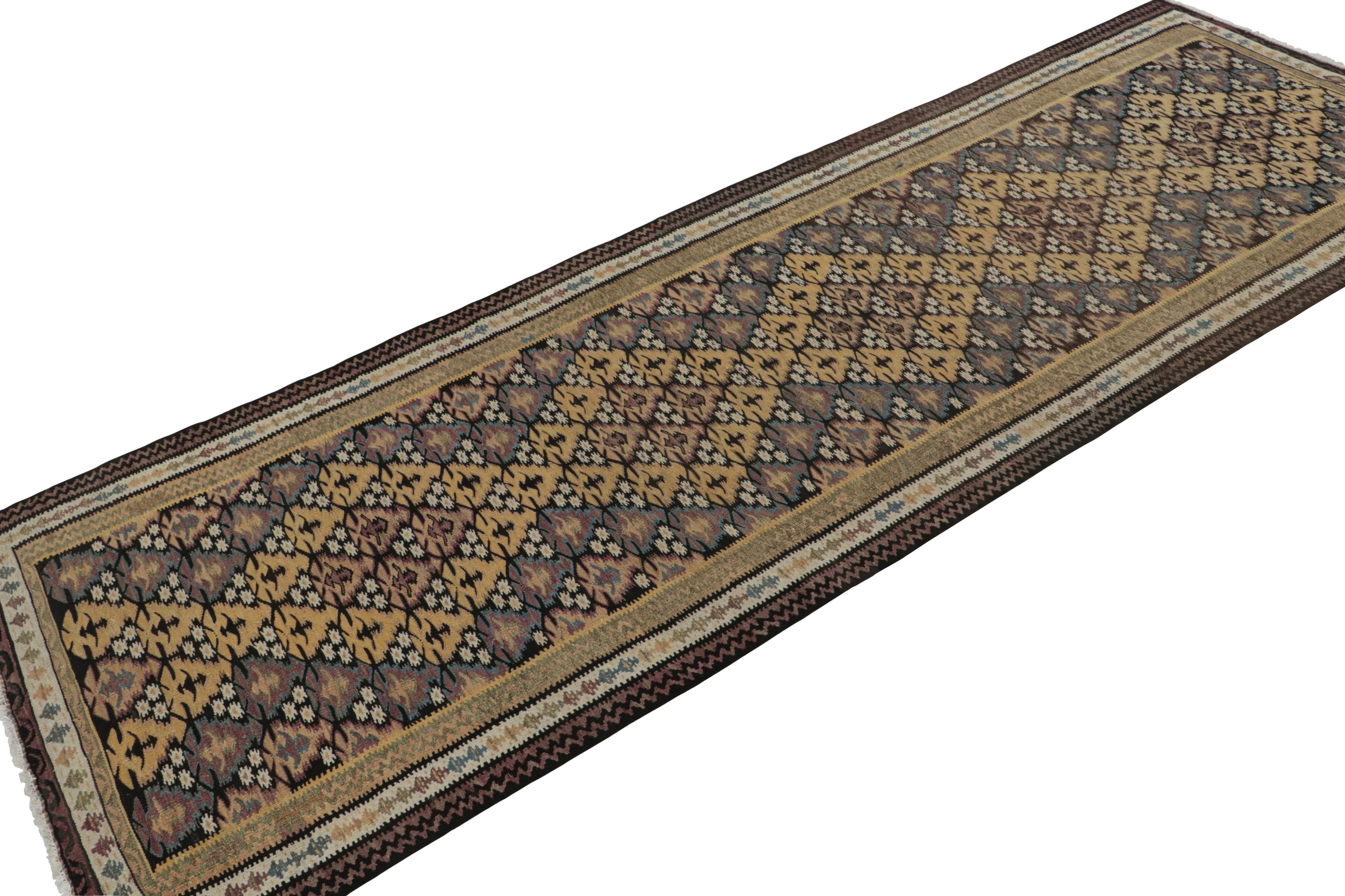 Hand-knotted in wool, this 3x10 vintage Persian tribal runner rug has mosaic-like geometric patterns in gold, beige/brown, blue and pink, all over the field. 

On the design: 

Connoisseurs will appreciate the vibrant blend of a playful color