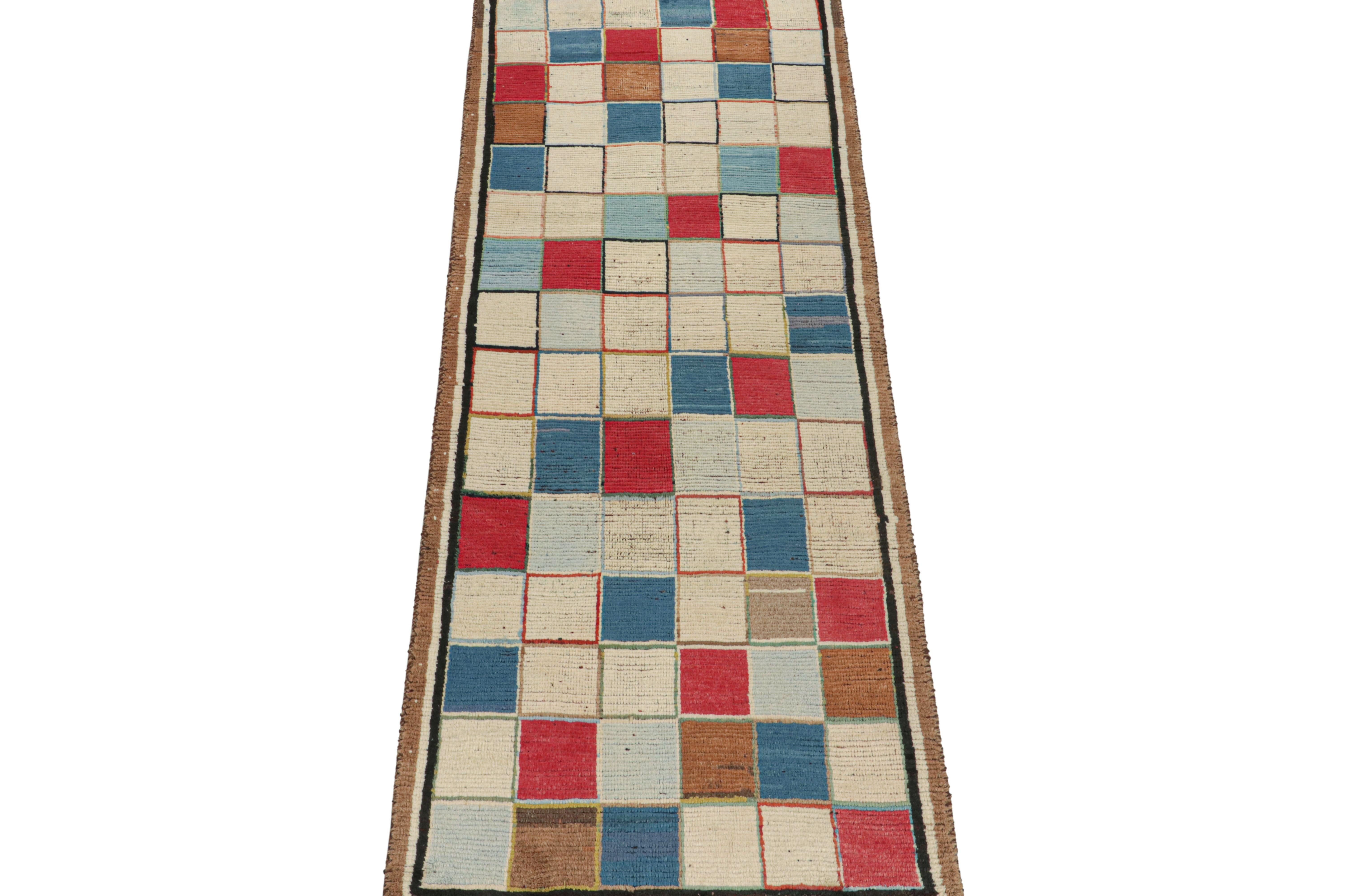 This vintage 3x9 Persian runner is a rare mid-century tribal rug, hand-knotted in wool circa 1950-1960.

Its design enjoys a series of square geometric patterns in off-white, brown, red, and blue hues. Connoisseurs will note how modern this piece