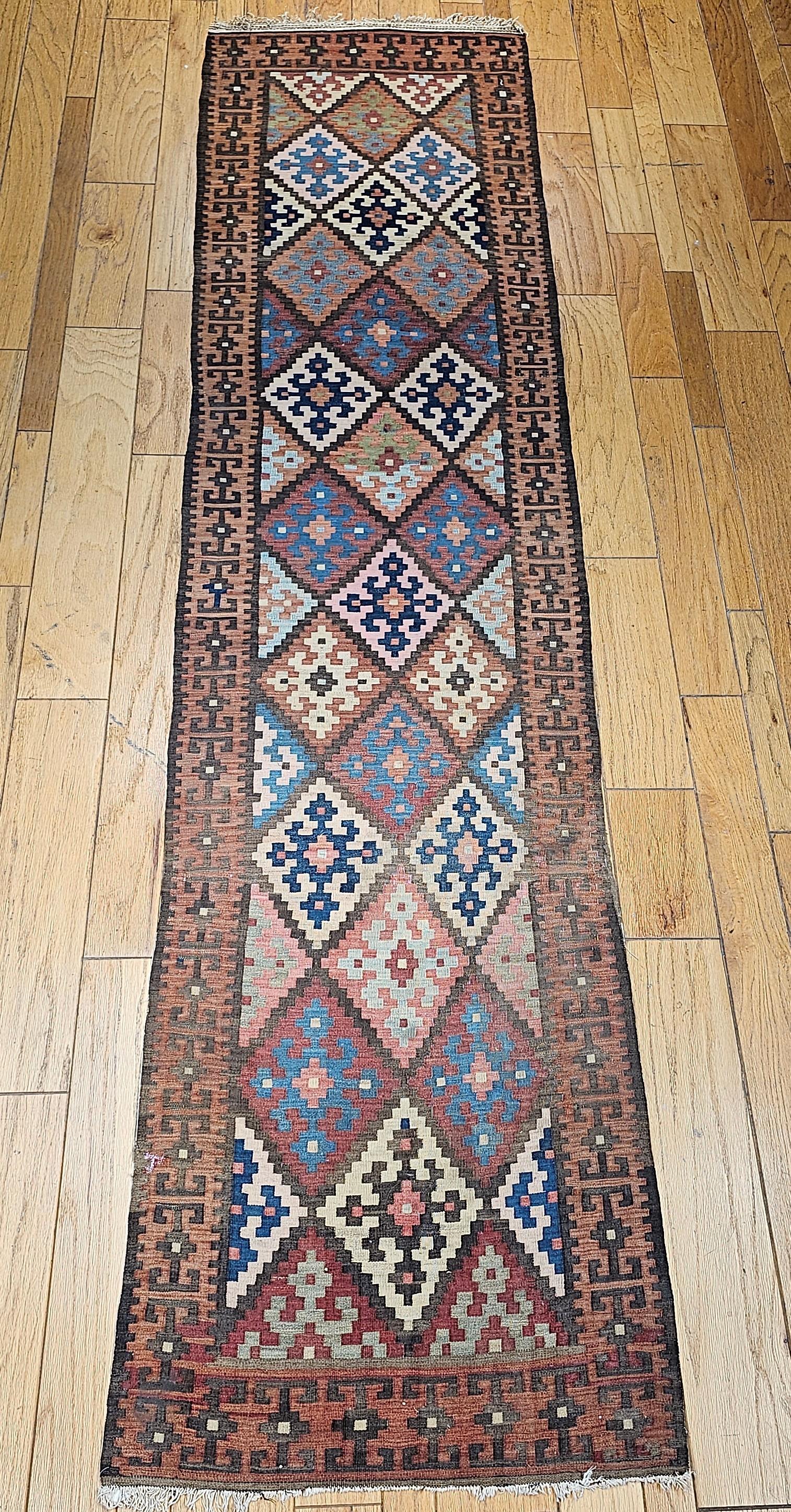 Vintage Persian Kilim (flat woven) runner is from the Varamin village (a city located on the ancient Silk Road) in north central Persia.  It has a brilliant geometric design and wonderful colors.   Beautiful Varamin Persian kilim runner in