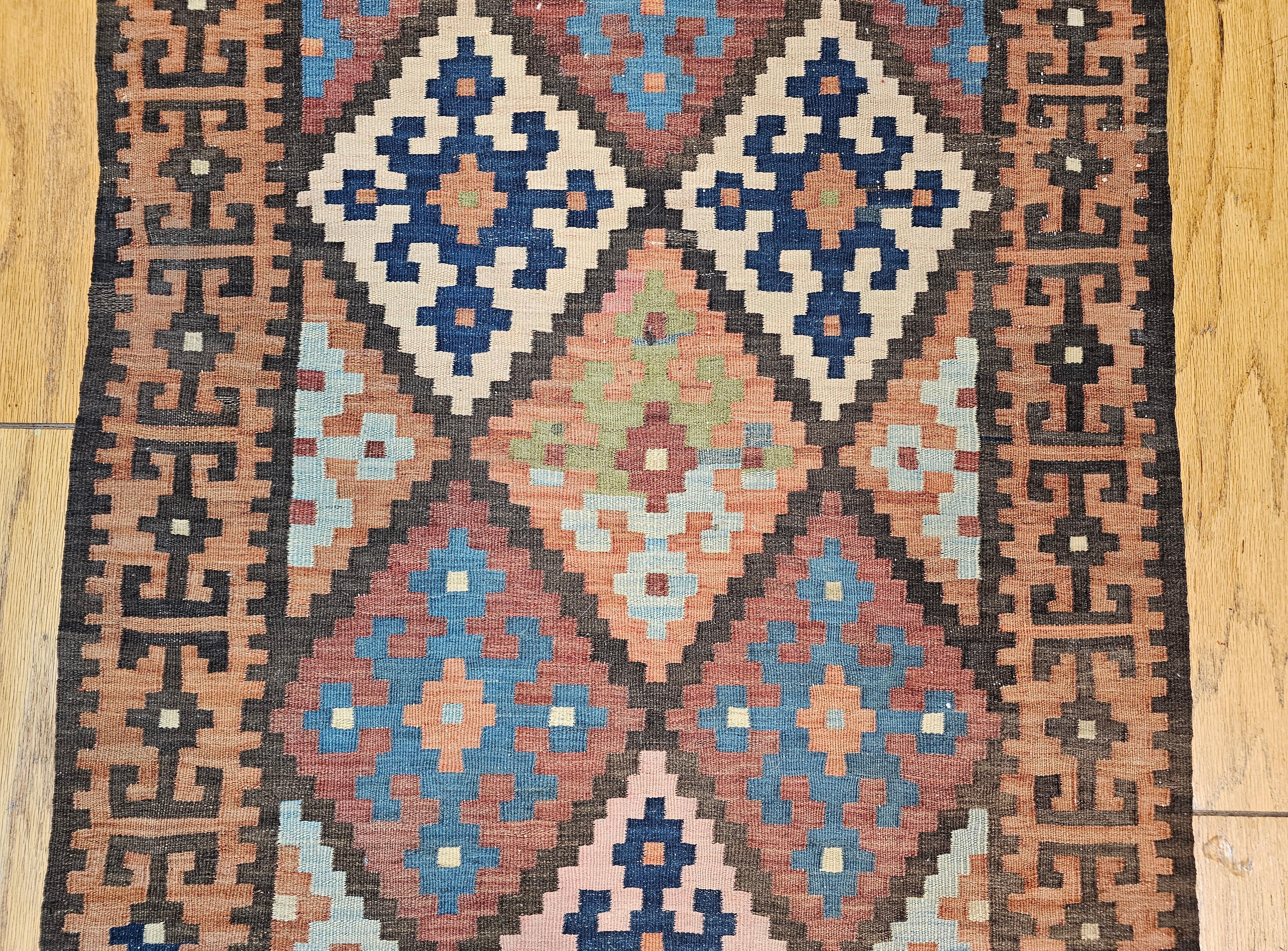 Vintage Persian Varamin Kilim Runner in Blue, Brown, Green, Yellow, Pink In Good Condition For Sale In Barrington, IL