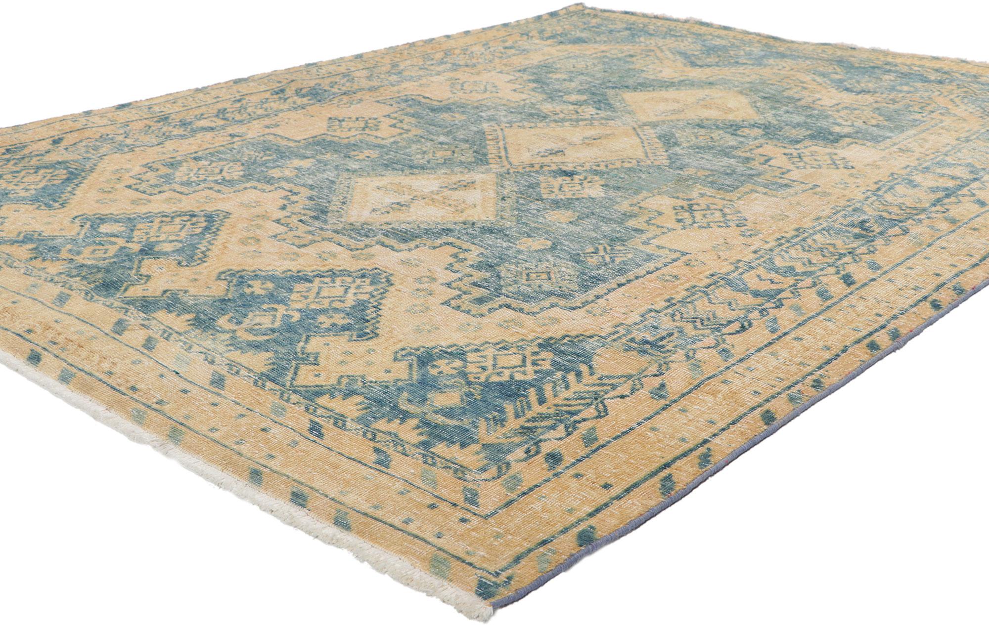 61121 Distressed Vintage Persian Viss Rug, 04'10 x 06'07.
Tribal mystique meets laid-back luxury in in this hand knotted wool distressed vintage Persian Viss rug. Let yourself be whisked away on a beguiling journey of enigmatic elegance, as you step