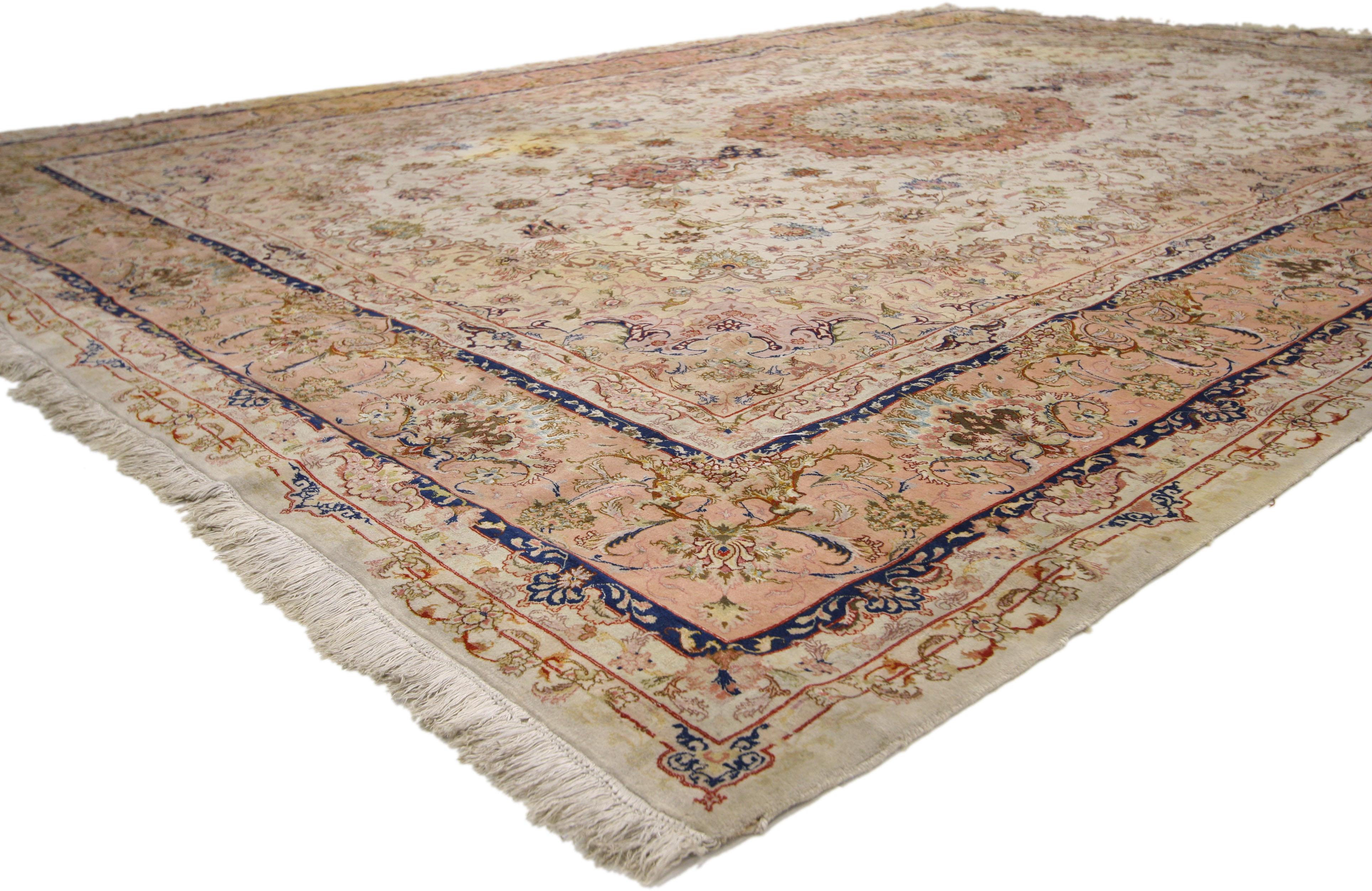 77182 Wool and Silk Vintage Persian Tabriz Rug, 09'09 x 13'05. With a harmonious blend of French Rococo elegance and Persian craftsmanship, this wool and silk Tabriz rug showcases a delicate interplay of light and airy colors. At its center lies a