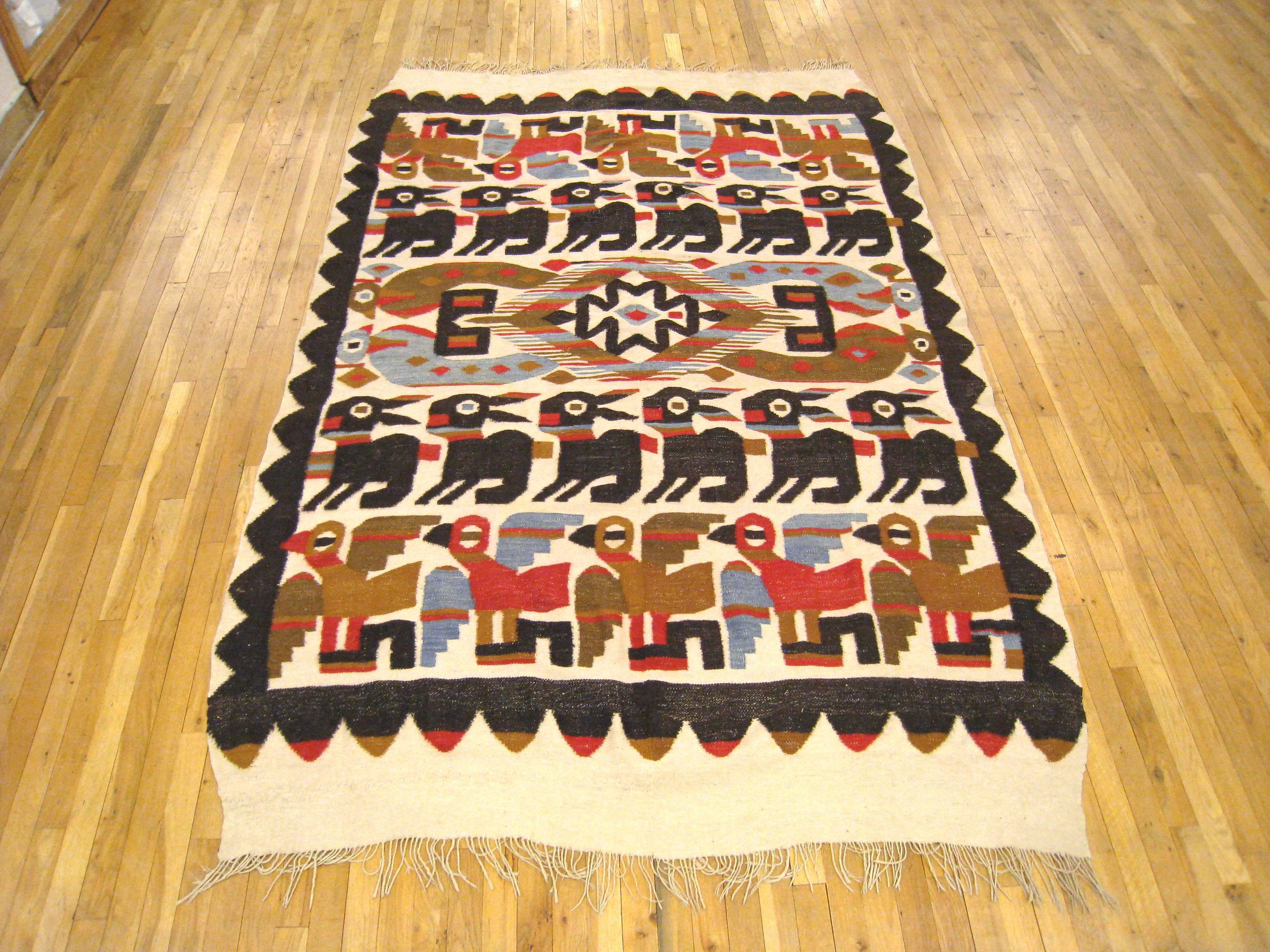 A vintage Peruvian flat-woven rug with a stylized 'Chancay' design, circa 1930. Size: 8'8 x 5'3. This lovely handwoven carpet features alternating rows of stylized bird and rabbit motifs. This is a flat woven rug, hand woven with wool, but with no